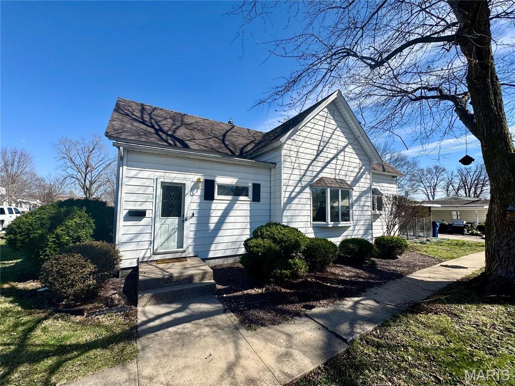 Welcome to 515 Madison Street in Canton, MO. A solid home that combines comfort and practicality. Step inside to a welcoming foyer and transition into a spacious living room with refinished hardwood floors that exude strength and character. With two living areas, you’ll have plenty of room to unwind or entertain. The kitchen is equipped with sturdy oak cabinets, a central island, and ample storage space for all your culinary endeavors. Enjoy the convenience of main-level laundry and two well-sized bedrooms, one featuring a walk-in closet. The addition, built in 2018, boasts a gas fireplace, bar, hardwood floors, and built-in display cabinets, ideal for gatherings or a quiet night in. Looking for a third bedroom? Customize the addition to fit your needs. Start your day with coffee in the screened-in porch or host friends on the patio. The detached two-car garage is perfect for parking or projects, while the flat yard offers space for play or gardening. Conveniently located, this home puts you in the heart of small-town living. Bonus- Prior to closing, the home roof will be replaced with shingles.