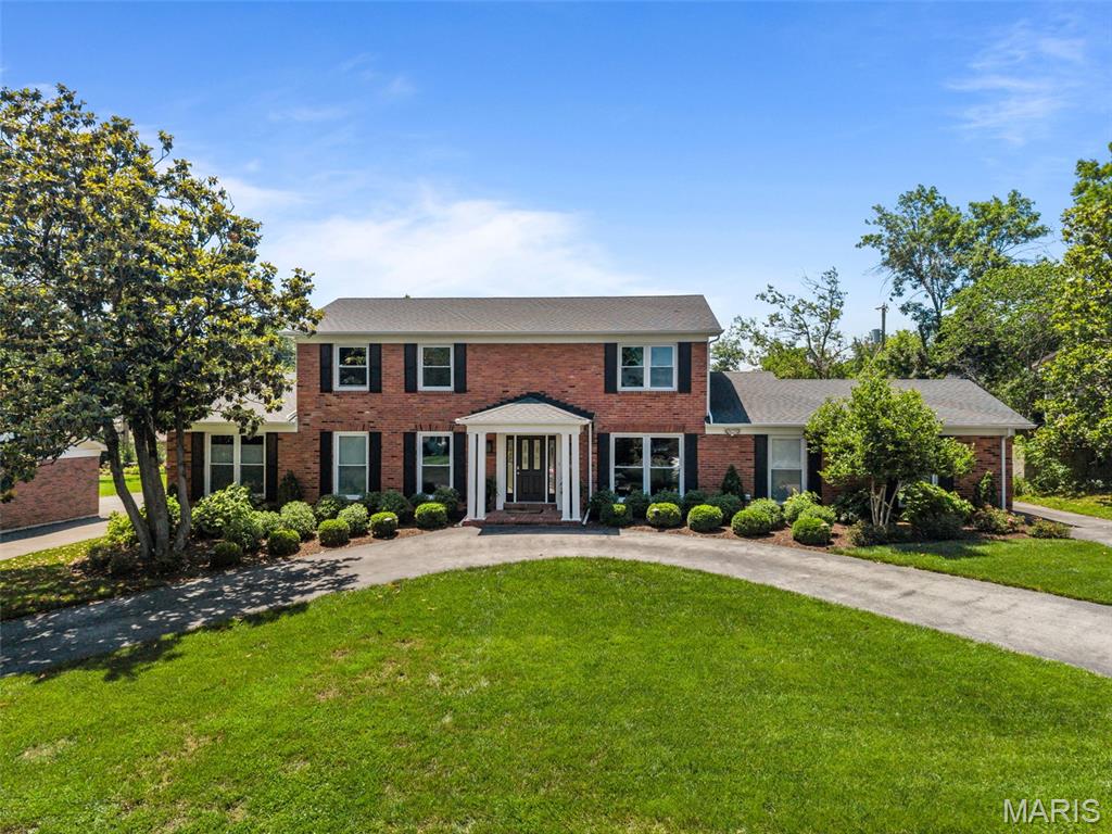 Welcome to this beautiful brick home in Olivette, full of thoughtfully designed updates both inside and out. You'll have wonderful curb appeal with impeccable landscaping, a horseshoe drive and rear-entry garage. The foyer opens to the living room on the left and dining room to the right, featuring picture windows, millwork, and crown molding, and gleaming hardwoods that continue throughout the home. The family room has a cozy gas fireplace with floor-to-ceiling tile surround and built-in bookshelves. The showstopper kitchen has been updated with quartz counters, 42" cabinets with crown molding and integrated lighting, top-of-the-line stainless steel appliances, an island with a breakfast bar, and tile backsplash. Off the kitchen is the screened-in porch, complete with a TV hook-up, perfect for enjoying a summer evening in the shade. The primary suite is retreat with a spa-like bathroom complete with granite vanity and tile-surround step-in shower and a vast walk-in closet with organization system. A half bath and laundry room complete the main level. Upstairs is a guest suite with dual-sink vanity and corner shower. The spacious 3rd, 4th, and 5th bedrooms share an updated bath with dual sinks and tile-surround tub. The finished basement adds a large family room with a granite wet bar, office, gym, and bathroom. You'll have an amazing outdoor space for hosting gatherings! Relax with friends and family on the paver patio with an outdoor fireplace, all overlooking the landscaped backyard. In a great location, just moments from all of the shopping and restaurants along Olive Blvd., with quick access to Laude Schools, Downtown Clayton, 170, parks, and University City, this home is one you won't want to miss!