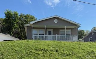 This Cottage style home has been remodeled and looks bright and cozy.  3 nice bedrooms and 2 full baths with a large living room, dining room ,kitchen and utility room ...all on one level....this adorable home has a one car detached garage.  Located in a small neighborhood in West Waynesville...walking distance to the Waynesville 6th grade center, Middle school, and local shopping .  Approx 15 minutes to the West Gate of Fort Leonard Wood.  This adorable home just had new sewer line installed...May 2026