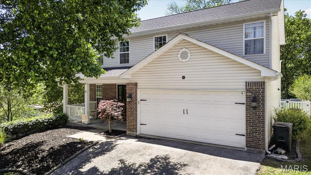 Welcome home to this beautifully maintained and decorated Two Story residence featuring 3BR/3.5BA and a spacious Finished Lower Level, all situated on a private .23-acre lot.  The attractive brick and vinyl maintenance free exterior is complimented by a large covered front porch and an inviting front entry with sidelights.  Inside, you’ll love the Open Floor Plan filled with natural light.  The Main Level features luxury vinyl plank flooring throughout and a spacious Family Room with a gas fireplace, ceiling fan, and a wall of windows overlooking the large, fenced backyard.  The Family Room flows seamlessly into the Breakfast area and Kitchen, creating the perfect space for everyday living and entertaining.  The Kitchen offers white cabinetry, stainless steel appliances, a gas stove, pantry, and convenient breakfast bar seating.  A sliding glass door leads to the private, level back yard featuring a large patio with a Pergola for shade, a garden area, and mature woods behind the property, providing exceptional privacy.  Upstairs, the expansive Primary Suite boasts a vaulted ceiling, ceiling fan, walk in closet, and an En Suite bath complete with a large comfort height vanity, separate shower, and soaking tub.  Two additional generously sized bedrooms and a full bath complete the upper level.  One of the secondary bedrooms features French doors opening to a private balcony overlooking the backyard.  The beautifully finished Lower Level offers Luxury Vinyl Plank flooring, large windows that provide abundant natural light, a dedicated office area, a full bathroom, and a storage area with laundry hookups.  Recent updated include new upstairs carpeting (2024), a replaced gas fireplace system (2025), and new Lower Level flooring (2025).  Additional improvements include a newer furnace and AC, and a 4 year old roof.  Lovingly cared for and meticulously maintained, this exceptional home offers comfort, space, and privacy in a highly convenient location with easy access to Highways 141 and 44.