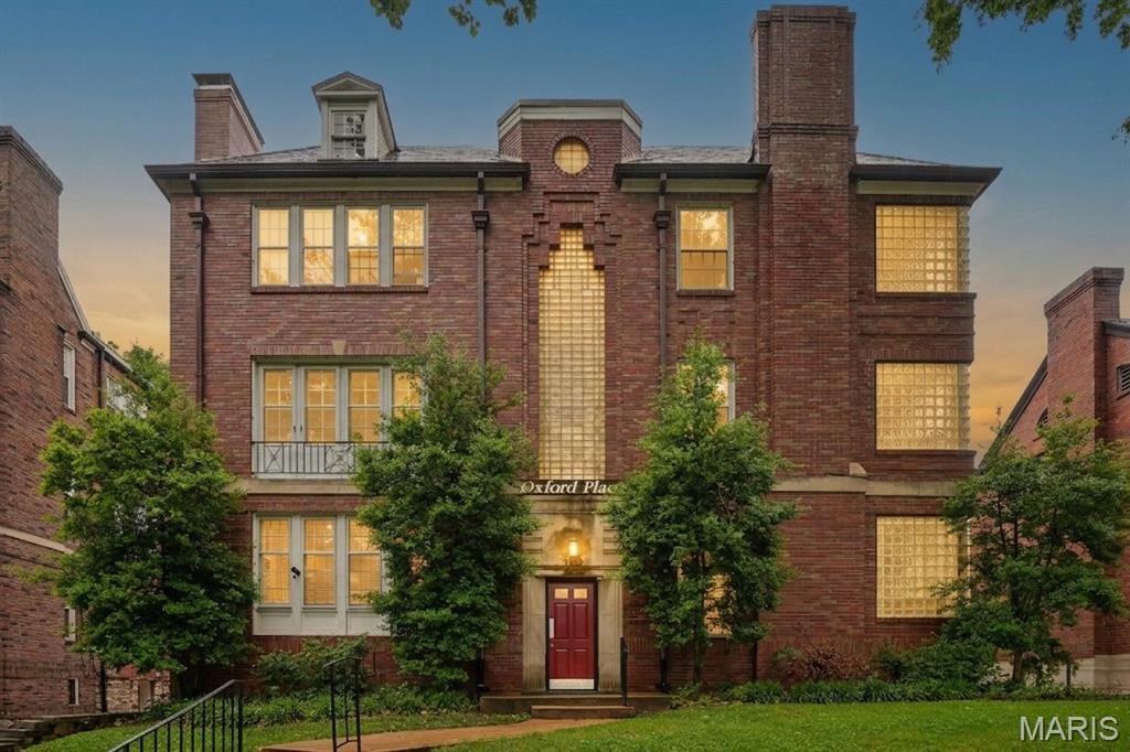 Stunning 3 bedroom Clayton condo in the heart of the sought-after Moorlands neighborhood, showcasing exceptional upgrades and designer finishes. This sun-filled, south-facing main-floor unit offers beautifully refinished hardwood floors throughout—no carpet here—and abundant natural light in the spacious, inviting living room. There is plenty of beloved charm with original fireplace, moldings, built-ins, and high ceilings coupled with a modern layout and amenities. The open-concept kitchen and dining area is ideal for entertaining, featuring a gas range with vented hood, upscale stainless steel appliances, custom tile backsplash, tile flooring, and an impressive center island with a telescoping table for added flexibility. It's sure to be the focal point for many social gatherings to come. 
Both full bathrooms have been thoughtfully renovated with one-of-a-kind, luxury finishes. The rear bath is a true standout with heated floors, a large walk-in shower with custom tilework, and even a built-in dog washing station. Additional highlights include in-unit laundry, an attached garage space with a 240V EV charging outlet, and a storage room. Major updates provide peace of mind, including a newer high-efficiency HVAC system, recessed LED lighting, newer building hot water heater (covered by HOA), newer roof, and custom plantation shutters throughout. Move-in ready and perfectly located near Clayton’s premier dining, shopping, parks, amenities and award-winning schools—this one is truly a must-see.