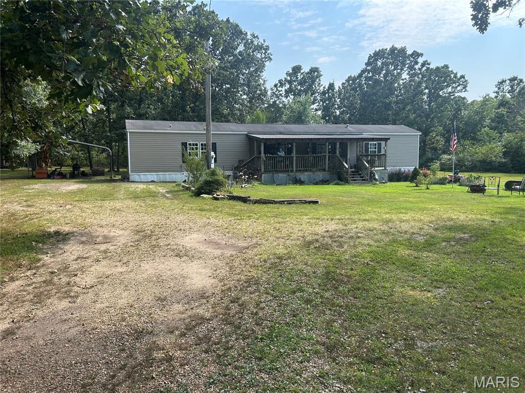 Welcome home to a beautiful property tucked away in a quiet, peaceful setting, yet conveniently located just minutes from town. This property offers plenty of space,  privacy, and outdoor amenities for enjoying the best of country living. The mobile home features a covered front porch perfect for relaxing and enjoying the peaceful surroundings, along with a large back deck that provides plenty of room for entertaining, grilling, or enjoying your morning coffee. A above ground swimming pool offers a wonderful place to cool off and make memories during the warmer months. The property also includes a charming camping cabin that could make a great guest house, providing a comfortable space for visiting family, friends, or weekend guests. The fenced yard gives you plenty of options and is ideal for children, dogs, or even a few chickens. A beautiful pond stocked with fish adds to the peaceful country atmosphere and provides a great spot to relax, fish, and enjoy the outdoors. Location is another major plus. You're just 3 miles from a small town with the essentials, including a Dollar General, post office, and gas station. When you need more, Rolla is only about 18 miles away, offering hospitals, Walmart, shopping, restaurants, and just about everything else you could need. Outdoor enthusiasts will love the property's convenient access to Mark Twain National Forest, the Big Piney River, and several nearby trout streams, making it easy to enjoy hiking, fishing, floating, camping, and exploring the beautiful Ozarks. If you're looking for a peaceful place with plenty of outdoor amenities, room for family and pets, and convenient access to both small-town necessities and larger-town services, this property is worth a look. It offers the perfect combination of country tranquility, recreation, and convenience.