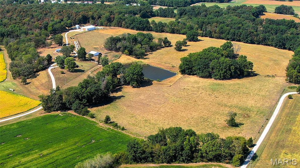 The perfect blend of productivity, beauty, and lifestyle on this remarkable 163-acre farmstead, located in Southern Lincoln County. With a balance of 96 acres high productive Cuivre River bottom loam soil, 35 acres of mature woods, 25 acres of pasture, and 7 acres dedicated to a comfortable residence and outbuildings, this property is designed for both agricultural success and country living.

Set at the top of a bluff overlooking the Cuivre River Valley, amidst gently rolling farmland and rich bottom ground, the stately centerpiece is a 1,827 sq. ft. all-brick home featuring 3 bedrooms, 2 baths, a two-car garage, and a partially finished, walk-out basement. Surrounded by open skies and pastoral views, the residence offers a timeless foundation for family gatherings and rural living.

The working farm is equipped with a 54’x81’ Morton Building with partial concrete floor, cattle shed, loafing shed, and two 3,700-bushel grain bins—providing ample space for equipment, feed, and harvest storage. Multiple outbuildings add versatility to the operation, while fenced and cross-fenced pastures with large pond create ideal conditions for livestock.

Whether you’re seeking a working row-crop and livestock farm, a hunting and recreation retreat, or a multigenerational homestead, this property delivers unmatched opportunity.

Deed Restrictions: No Mobile, Modular, Manufactured Homes. No landfill, junkyard, quarry, or mining allowed on property.