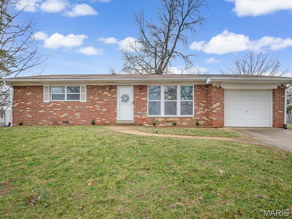 Charming and move-in ready, this 2-bedroom, 1-bath brick ranch offers a comfortable layout and modern updates in a convenient Fairview Heights location. Step inside to a bright, open living area filled with natural light, highlighted by a stylish accent wall with an electric fireplace that serves as a welcoming focal point. The space flows easily into the updated kitchen featuring white cabinetry, stainless steel appliances, generous counter space, and a breakfast bar that opens to the living area. Just off the kitchen is a flexible dining space with sliding doors that lead to the backyard, making it easy to enjoy indoor and outdoor living. Down the hall, you’ll find two bedrooms and a full bath. A large separate laundry room with additional cabinet storage adds everyday convenience. Outside, the backyard provides space to relax, garden, or entertain. Located near shopping, dining, parks, and major highways, this home offers a great opportunity for buyers looking for a move-in-ready property with style and functionality.