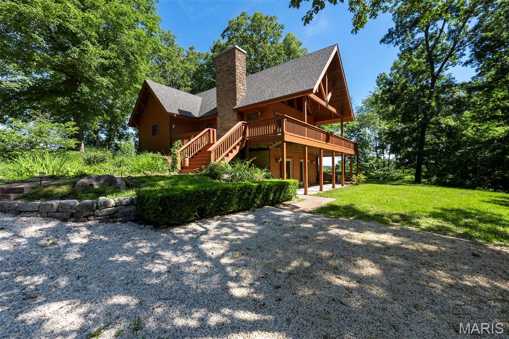 Welcome to this beautiful and truly unique property in a fantastic location, offering privacy, character, and endless opportunity. As you arrive, a private drive leads you to a stunning cedar-wrapped home highlighted by a large porch and expansive windows that bring the outdoors in.  Inside, you’ll immediately appreciate the craftsmanship with rustic wood beams, vaulted pinewood ceilings, and a striking stone wood-burning fireplace anchoring the open floor plan. The main-level provides an open floor plan with kitchen and dining room combo, primary bedroom that features a spacious tile shower, along with the convenience of main-level laundry. Upstairs offers two additional bedrooms and a full bathroom. The fully finished walk-out basement expands your living space with a large family room, fourth bedroom, two bonus rooms, and a full bathroom—perfect for guests, hobbies, or multi-generational living.  Recent upgrades include a new roof, exterior wood siding freshly stained in 2025, and meticulous ongoing maintenance throughout the home. Next to the 2 car garage you'll notice a major bonus for comfort and efficiency is the wood-burning stove that efficiently heats the entire home, providing exceptional warmth during colder months.

In addition to the residence, the property includes a remarkable second building styled as a Treehouse. This 2,500+ sq. ft. space features rustic wood ceilings, barn wood accent walls, large windows, and a stunning 30 x 40 private wood deck surrounded by trees, creating a peaceful and inviting setting. The building includes a commercial-style kitchen, dish room, full bar, two bathrooms, and ample storage. With its layout and setting, it offers incredible potential for revenue generating opportunities for special events such as weddings, parties, restaurant, bar, or even a potential Airbnb.

The property also includes an existing shop and footings already poured for a 40 x 50 shop near the main road, adding even more flexibility and value.

This is a rare opportunity to own a one-of-a-kind property that blends rustic luxury, functionality, and income-producing potential—all in one exceptional setting.