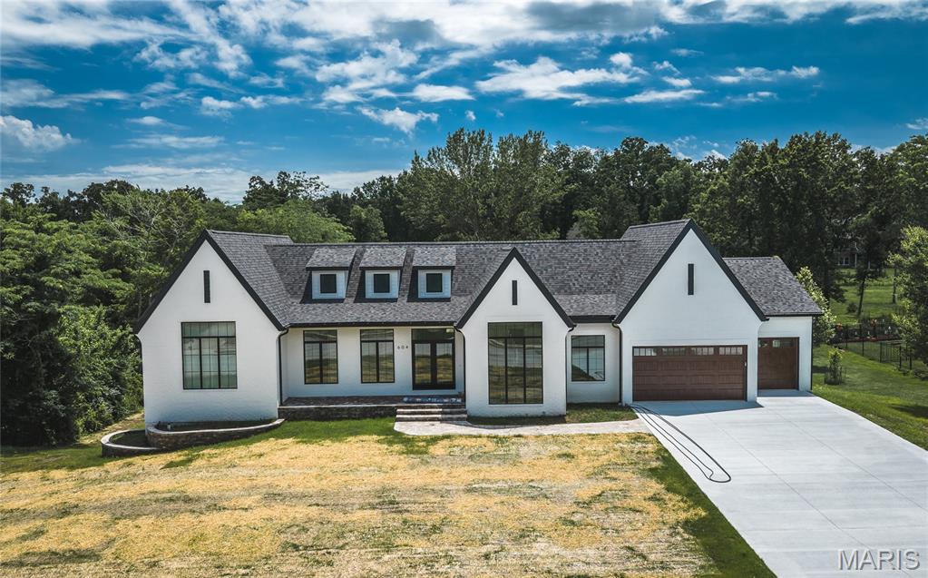 Welcome to a truly exceptional luxury residence where sophisticated design, master craftsmanship, and cutting-edge technologies come together to create one of the finest new construction homes ever available in Rolla. Spanning an impressive 4,279 square feet, this 5-bedroom, 4.5-bath custom-built Smart Home has been meticulously designed for those who appreciate uncompromising quality paired with timeless elegance. From the moment you step through the entry, the home's grand scale becomes immediately apparent. Soaring vaulted ceilings, stunning architectural details, and rich hardwood floors create a sense of warmth and refinement rarely found in modern construction. Every finish has
been carefully selected, every line intentionally designed, and every room crafted to offer a seamless balance of luxury and livability. At the heart of the home lies a chef-inspired kitchen and galley that rivals those found in custom estates. Beautiful quartzite countertops, premium KitchenAid appliances, a downdraft range, double oven and microwave combination, smart
charging integrated into the island, and custom real-wood cabinetry with pull-out organizers combine functionality with extraordinary style. The exquisite Mother of Pearl backsplash serves as a striking focal point, while multiple stages of custom crown molding elevate the space to an entirely different level of sophistication. The galley itself showcases a refined wood paneled finish rather than traditional drywall and has been prewired for art lighting, creating a gallery-like
atmosphere perfect for displaying treasured artwork and decor. Attention to detail extends far beyond aesthetics. Pella casement windows and doors flood the home with natural light while enhancing energy efficiency. Custom, integrated floor vents, recessed receptacles, 100% LED lighting throughout, soft-close cabinetry, and solid 8-foot wood doors demonstrate the builder's commitment to quality at every turn. Soft-close pocket doors add both functionality and
elegance while preserving clean architectural lines throughout the home. The primary suite serves as a private sanctuary designed for ultimate relaxation. The spa-inspired ensuite bathroom features radiant heated floors that provide year-round comfort, creating a luxurious retreat at the beginning and end of every day. On the main level, all bathrooms have been
sound-deadened, offering an added layer of privacy and tranquility rarely considered in traditional home construction. Designed for modern living, the home's intelligent systems and energy-efficient construction work together to provide comfort, convenience, and long-term savings. The low-maintenance exterior allows homeowners to spend less time on upkeep and more time enjoying the lifestyle this remarkable property affords. With five spacious bedrooms, four and a half beautifully appointed bathrooms, and expansive living spaces designed for entertaining, this home effortlessly accommodates both intimate family gatherings and large-scale celebrations. Every square foot reflects a dedication to craftsmanship, innovation, and luxury that is increasingly difficult to find. This is more than a home-it is a statement of
excellence. For the discerning buyer seeking unparalleled quality, exceptional design, and a residence built without compromise, this extraordinary Rolla property represents a rare opportunity. Schedule your private tour today and experience firsthand what luxury living was meant to be.