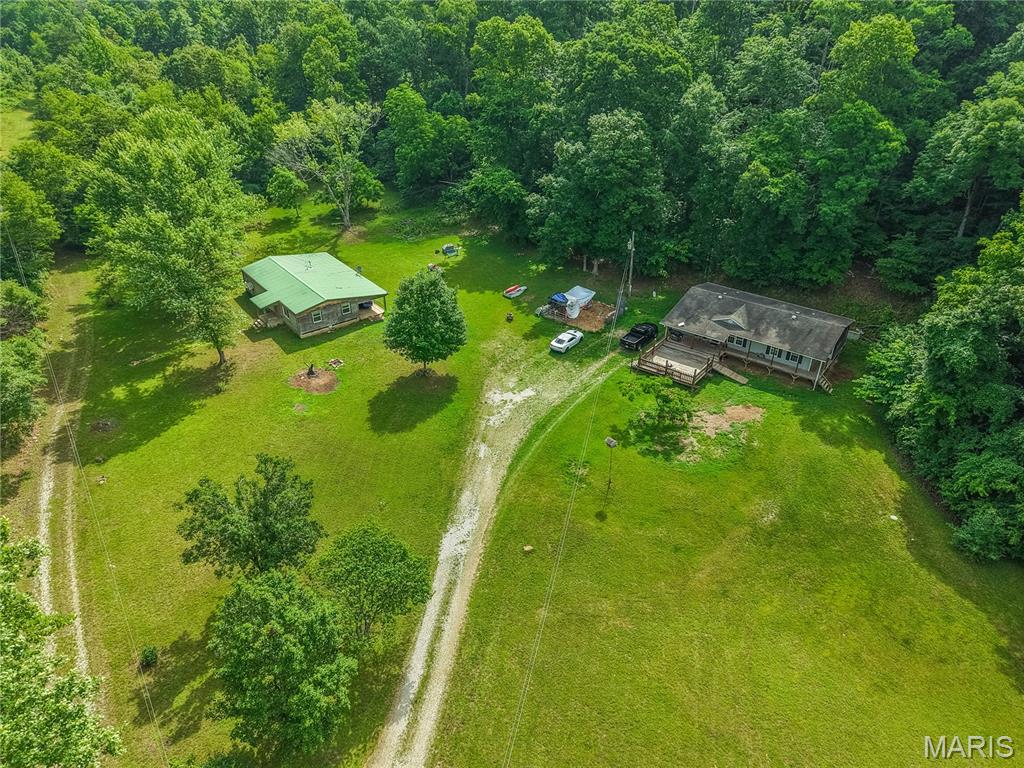 Escape to the Ozarks with this private 42+/- acre property located at 3822 Wayne Route BB in Greenville, Missouri. Tucked away at the end of the road, this secluded retreat offers unmatched privacy while adjoining thousands of acres of Mark Twain National Forest and sitting less than 2 miles from the Page Branch boat ramp on Wappapello Lake, making it a true outdoorsman's dream.

The property features a well-maintained 2013 all-electric double-wide home offering 3 bedrooms and 2 bathrooms, along with a covered front porch, deck, and a concrete pad already in place for a future garage or workshop. Also included is a second residence, a 1,486 sq. ft. 1971 double-wide with log siding, metal roof, propane heat, and propane range/stove. This home offers 3 bedrooms and 2 bathrooms but needs repairs, creating an opportunity for a guest house, hunting cabin, rental property, or renovation project. An old barn provides additional storage and character.

Loaded with wildlife, the owners regularly see deer and turkeys from the front porch. Whether you're looking for a full-time residence, hunting retreat, or recreational getaway, properties offering this much privacy, wildlife, and direct access to Mark Twain National Forest are hard to find.