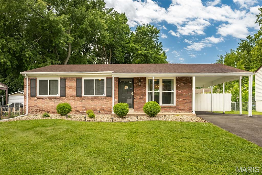 Welcome to this wonderful move-in ready brick ranch located in the heart of Maryland Heights. From the moment you arrive, you'll love the fantastic curb appeal, featuring a low-maintenance landscape bed, classic shutters, and a massive attached carport perfect for covered parking. Step inside to discover a bright and airy open floor plan accented by gorgeous, gleaming hardwood floors that flow throughout the main living spaces and bedrooms. The living room seamlessly connects to the heart of the home: a beautifully updated kitchen. Showcasing crisp white cabinetry, modern subway tile backsplash, slate-grey countertops, and sleek stainless steel appliances, this kitchen is as functional as it is stylish. The clever breakfast bar overlooks both the living area and the adjacent stairway, keeping you connected while entertaining. The main level offers 3 comfortable bedrooms and 1.5 bathrooms, including a renovated full bath complete with a chic grey vanity, updated lighting, and a custom tiled tub surround, alongside a convenient half bath off the primary bedroom. Need more space? The sprawling, fully finished basement is ready to become your ultimate rec room, home gym, or media center, complete with clean carpeting and recessed lightinf, plua two additional bonus rooms. Outside, the large, level lot is a rare find! Step out onto the concrete patio, which looks out over a fully fenced backyard lined with mature trees—providing the perfect canvas for summer BBQs, pets, or a future garden. Don't wait on this Maryland Heights gem—schedule your tour today!