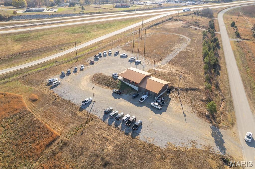 Available is a beautiful, commercial building and land at 140 West Outer Rd. in Poplar Bluff, MO.  This is just south of the M Hwy junction with Hwy 67 South, which will soon be Interstate 57.  This multi-use building offers 4560 square ft under roof and currently houses two businesses.  The main level has two entrances, one into what is now a beauty salon and the other into the truck sales offices.  The salon area is 14 X 27 with a break room/ store room.  The truck sales side has three large offices, a kitchen area, restroom and stairwell which takes you into the shop and storeroom areas.  This metal sided building has 1520 sf in office/kitchen/salon areas, 1520 sf. full basement which is currently utilized for storage and a 1520 sf. shop/garage area with 14 ft sidewalls.  This location offers great visibility from M Hwy and what is soon to be Interstate 57, as well as a graveled parking lot. All this sits on 3.82 acres m/l with plenty of room to expand or build an additional business.