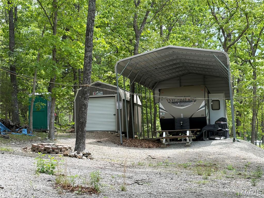 Camping lot for sale in a lake community! Enjoy gated access with 24/7 security and a wide range of community events for all ages. The 400-acre lake offers plenty of space for swimming, boating, skiing, and fishing. Additional amenities include parks and a community pool—perfect for relaxing and making lasting memories. Property includes a camper, carport, and shed—ready for you to start enjoying lake life right away!