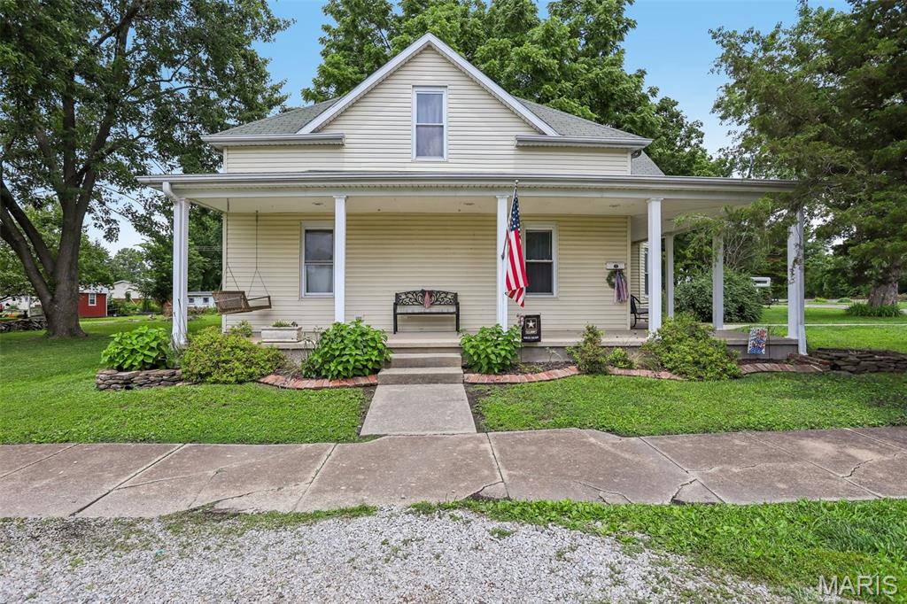 Step into a home with character you just don't find anymore. Sitting on a large corner lot, this 5-bedroom, 2.5-bath welcomes you with a beautiful half-wrap porch and warmth throughout. Inside, a spacious sitting area flows into the living room and on to a separate dining room. Tall ceilings and generously sized rooms give the whole home an open, airy feel. The main floor offers true one-level convenience with a bedroom, two full baths, and main floor laundry. Upstairs you'll find four more bedrooms, a half bath, and a mini split for year-round comfort. Out back, the screened-in patio with wood-burning fireplace is made for relaxing in any season. Kitchen appliances stay, plus two sheds and a carport for storage and projects. From the curb appeal to the layout to the details throughout, this one is worth seeing in person.
