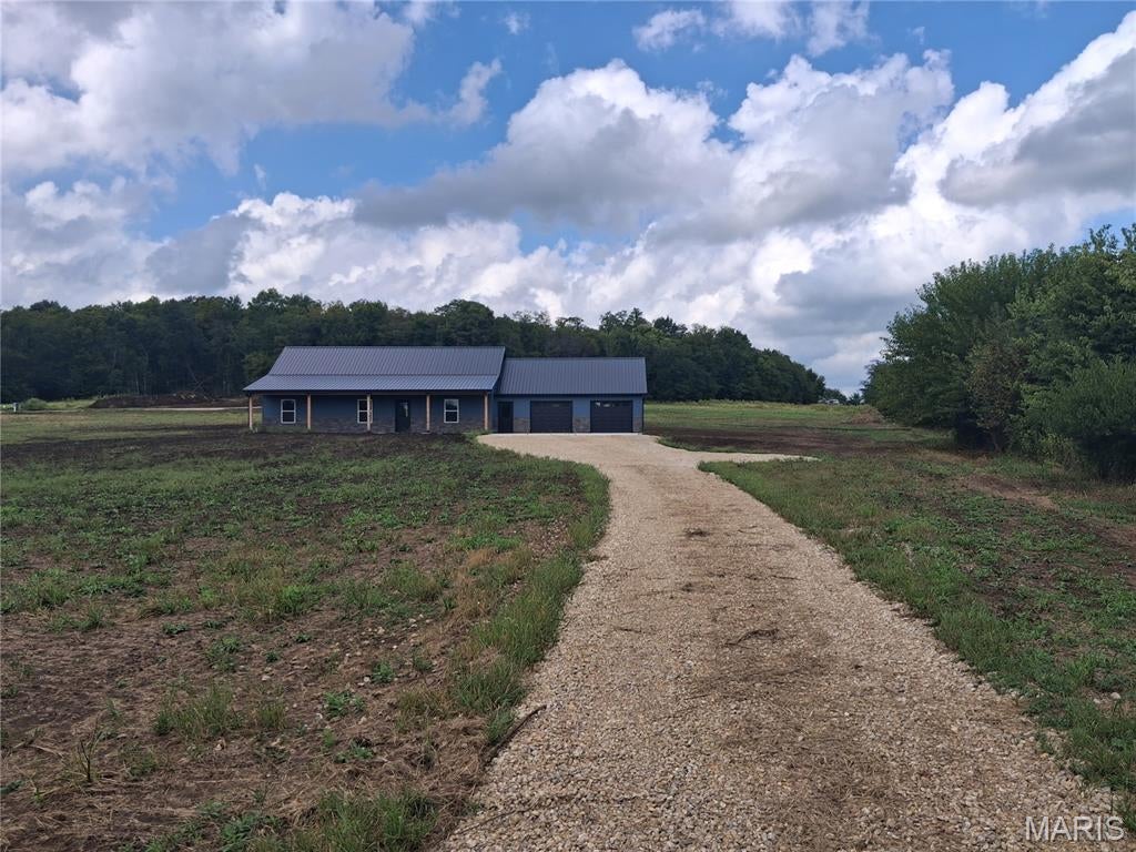 New Construction home located on blacktop frontage on Highway A, located just minutes from New London, MO and Hwy 61. The home features 3 beds, 2 full bathrooms, 2 car attached garage, open floor plan design with a spacious kitchen that comes with granite counter tops and stainless steel appliances. The new home sits on 3 m/l acres and comes with a one year builder warranty! The home sits on lot 10 of the subdivision. See pictures for reference.
