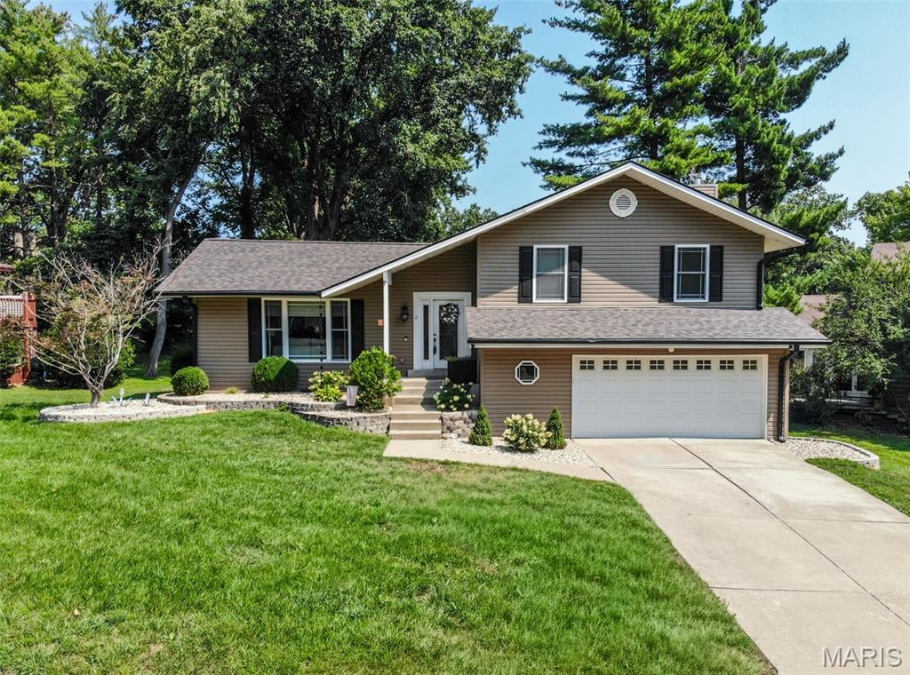 Welcome to this beautifully updated 3-bedroom, 3.5-bathroom multi-level home located in Lake St. Louis, complete with lake rights and a 2-car garage! Wonderful curb appeal welcomes you with new landscaping and front exterior lighting. Step inside to a spacious living room featuring vaulted ceilings, an open-concept layout, and modern updates. The new built-in electric fireplace, mantel, and entertainment center create a stunning focal point in the main living area. The kitchen is truly the heart of the home, offering an abundance of custom white cabinetry, granite countertops, stainless steel appliances, and a cozy breakfast room that opens to the covered wood deck—perfect for enjoying your morning coffee. Upstairs, the spacious primary suite features an updated bathroom with walk-in shower, along with two additional bedrooms and an updated full bath. The lower-level family room offers ceramic tile flooring, a cozy wood-burning fireplace, half bath, and French doors leading to the backyard. Step outside to enjoy the private outdoor space, complete with a concrete patio and firepit—an inviting setting for relaxing evenings, entertaining guests, and making memories year-round. The basement provides even more flexible living space with a bonus room ideal for an office, playroom, or storage, plus a large sleeping area with an additional full bath featuring a walk-in shower and a separate utility/laundry room. With lake rights and access to the many recreational amenities Lake St. Louis has to offer, this home is one you won’t want to miss!