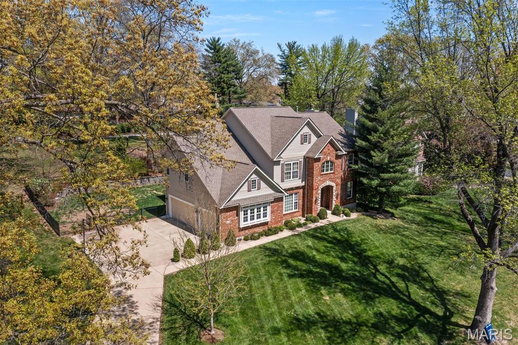 Lovely updated home in Ladue Schools on nearly half acre has grand street presence and warm interior! The entry foyer is flanked by generous dining rm and cozy living room which opens to the 2story great room -all with hardwood floors. The dramatic great room is the heart of the home with tall ceilings and stone fireplace, crown molding and updated lighting. Kitchen has custom white cabinetry, high end appliances, granite countertops and adjacent breakfast room. The butlers pantry is the walkway from kitchen to dining room--great for entertaining. Powder room and laundry complete main floor. Upstairs has oversized primary suite with new carpeting, bath with separate shower/tub and 3 additional bedrooms with 2 more bathrooms. 
Lower level is finished with private office, bathroom and tons of room for games and workout space.  The deck off the kitchen and great room is maintenance free and overlooks the fenced backyard. A whole house generator and surge protector has been added!!