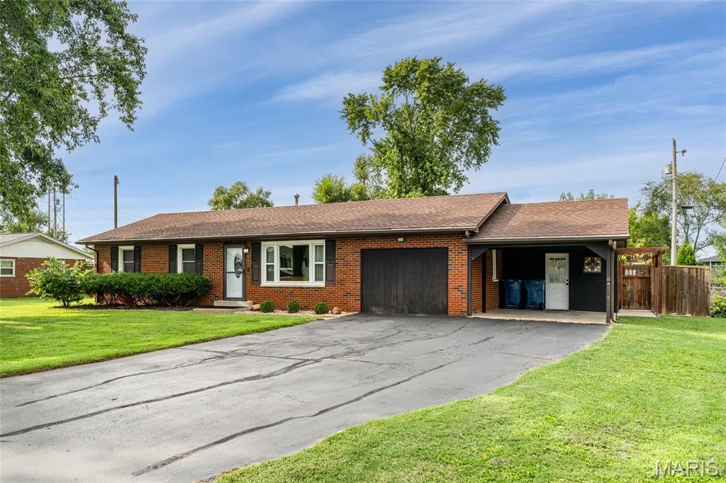 BEAUTIFUL! This meticulously maintained full-brick ranch is a true gem, offering over 1,400 square feet of beautifully updated living space, a fantastic backyard, and a flexible layout that can easily be converted back to a 3-bedroom home. The spacious primary bedroom is an incredible 20 x 11 and features three closets, while the second bedroom is generously sized as well. Both bedrooms offer newer carpet. The recently updated bathroom features a beautifully tiled tub/shower surround & new vanity. Tasteful LVP flooring flows throughout the home, complemented by upgraded thermal windows and a brand-new roof. The bright and inviting living room is filled with natural light. The former garage has been thoughtfully converted into a spacious family room with built ins (dog kennel is removable), providing additional living space, while the attached carport keeps your vehicle protected. The eat-in kitchen offers ample cabinetry and counter space, a double sink, and includes all appliances. Conveniently tucked behind closet doors, the main floor laundry area features additional shelving that provides excellent pantry storage. Step outside and discover the backyard you'll absolutely love! The incredible outdoor space features a patio with pergola, custom privacy fencing, large storage room, and shed—perfect for entertaining, relaxing, or enjoying summer evenings at home. Additional updates include HVAC (2015) and a new water heater (2026). With its brick exterior, thoughtful updates, flexible floor plan, abundant storage, and exceptional outdoor living space, this home truly checks all the boxes. Don't miss your opportunity to make this meticulously cared-for ranch your own! Contingent on seller finding home of choice.