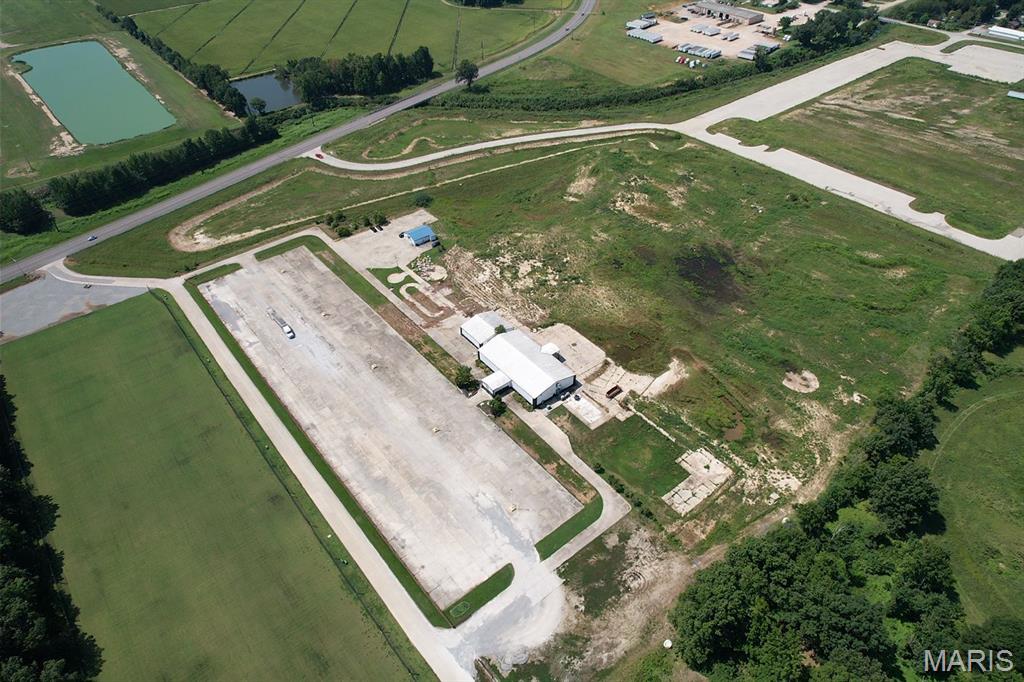 Commercial opportunity with 20 +/- acres! Endless possibilities await with this expansive commercial property offering incredible space, visibility, and versatility for a variety of business ventures. The property features two metal buildings, larger one currently occupied by a paying tenant that's a trampoline park, providing an established income-producing opportunity. With abundant acreage and major parking capacity, there is plenty of room to accommodate high-traffic operations, future expansion, additional development, or an entirely new business concept. The size and flexibility of this property open the door to a wide range of commercial uses. Whether you're looking for an investment property with an existing tenant, space to grow your own operation, or acreage to bring a new commercial vision to life, this property offers tons of opportunity an potential. A unique chance to secure a substantial commercial footprint with room to grow!