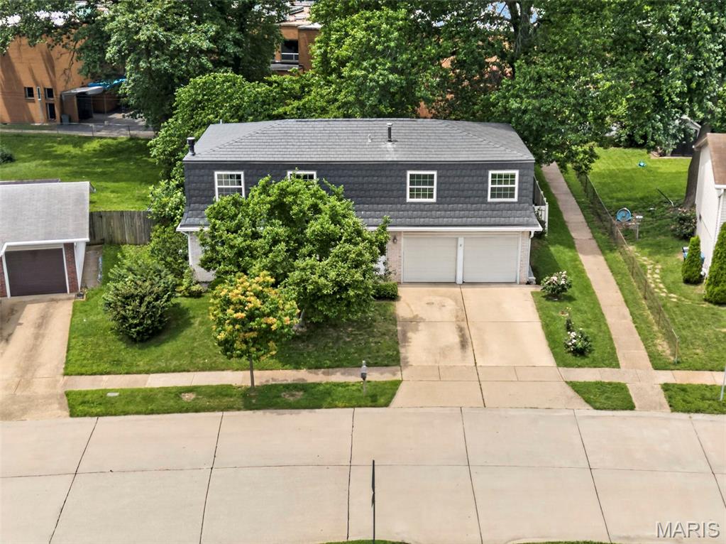 Looking for a home to raise your family or have space for multiple occupants? This original owner home offers 5 very spacious bedrooms & 3.5 baths, large fenced level back yard and finished lower level w/bar and full bath! All this in a great location in the desirable Pattonville School District! You'll be pleased with how much space this home offers! Very large great room with fan open to the kitchen with stainless appliances and gas cooktop! The spacious dining area is set up for a large table and walks out to the awesome level backyard, with great patio, vinyl fence, large trees and privacy, backing to a church so no neighbors behind you! Upstairs, you'll find space for everyone to have their own bedroom and still a final bedroom that could be your office if needed! The lower level offers a large family room with a bar, gas fireplace, built-in bookcases, and full bath! Extra deep (24') garage allows for the largest SUVs or Trucks! Long life metal roof! Home is in good shape, and is priced to sell reflective of updates needed. Seller to prefers to sell as is.  Maryland Heights inspection has been done, listing agent can provide details. Showings start Saturday June 6 at 12 noon.