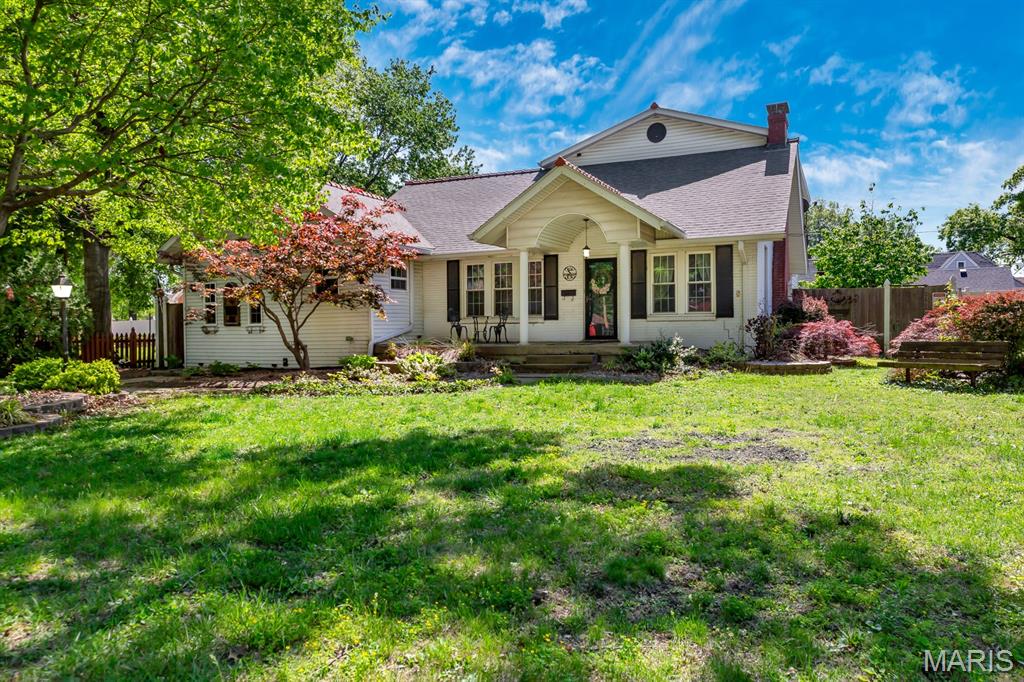 SPECTACULAR  1 1/2 STORY HOME - JUST STEPS AWAY FROM WILSON PARK! This charming home sits gracefully on a tree-lined street with sidewalks. Step inside and you'll get that cozy feeling. Inviting living room features a brick wood burning fireplace with lots of natural light and beautiful original hardwood flooring. The layout offers plenty of space for company or just everyday relaxing. The floors flow seamlessly into the spacious dining room with gorgeous accent wall - the perfect place to share a meal and gather with friends and family. This functional kitchen blends the original home with thoughtful updates - practical for daily life yet full of timeless charm. The expansive primary bedroom suite offers a walk in closet and private entry to bathroom and vanity space. The second bedroom is roomy and offers ample closet space. Now....let's talk about the family room / man cave - a cozy retreat to watch your favorite teams. So much potential to make it whatever fits your needs. Let's go upstairs to see the enormous 3rd bedroom - stretching 33 feet long and 22 feet wide. Wonderfully private and removed from the hustle and bustle of the main floor - large enough to make it a bunk room. Multiple walk in closets offer amazing storage options. Step downstairs into this expansive family room / recreation room - ample space for multiple seating areas, making it ideal for movie nights, game days, or just unwinding after a long day. Adjacent to the family room is a retro wet bar. Ready to make happy hour legendary again? Whether you're mixing cocktails for date night or hosting the big game, this wet bar turns every occasion into something special. A great multifunctional space that adds tremendous living square footage. Another full bathroom, practical and convenient. Office area is just shy of finished but is such a useful space. The unfinished portion of the basement has laundry hookups and great for storage. Step out back and view the expansive paver patio and tiki bar - complete with a privacy fence. Oversized 2 car detached garage - rear entry with garage door opener. Great curb appeal! This home is full of character, warmth, and the gentle rhythm of life by the park - Just move in and start making memories! Buyer's to verify all MLS data, including but not limited to, square footage, measurements, lot size, taxes, exemptions, etc.