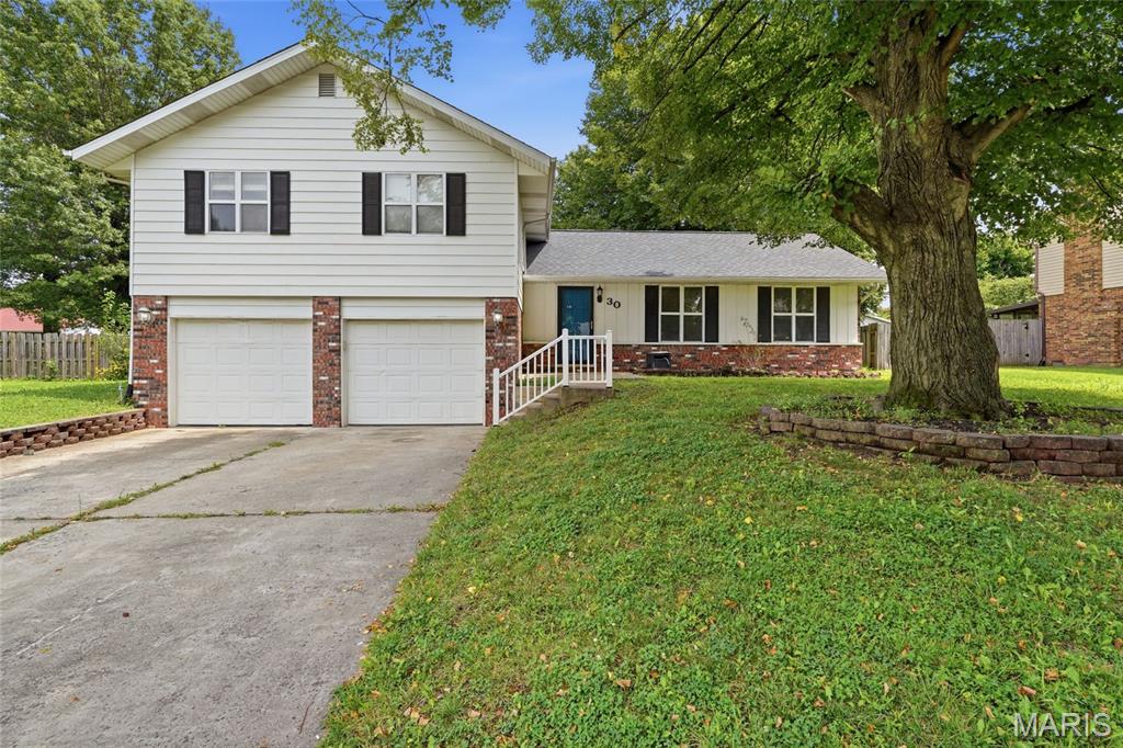 30 Mar Jacques Dr is a multi-level Belleville home built in 1981, set on a spacious fenced lot. The kitchen features white cabinetry, generous counter space, luxury vinyl plank flooring, and stainless steel appliances, flowing into the dining area with backyard access. A comfortable living room is anchored by a full-height brick fireplace. Four bedrooms provide flexible space, including a primary bedroom with a walk-in closet, served by three full bathrooms that include double vanities and both walk-in showers and tub combinations. A finished lower level adds bonus living space. Outside, a covered patio and fully fenced backyard extend the living space, and an attached three-car garage completes this well-maintained residence. Included 100-Day Home Warranty with buyer activation