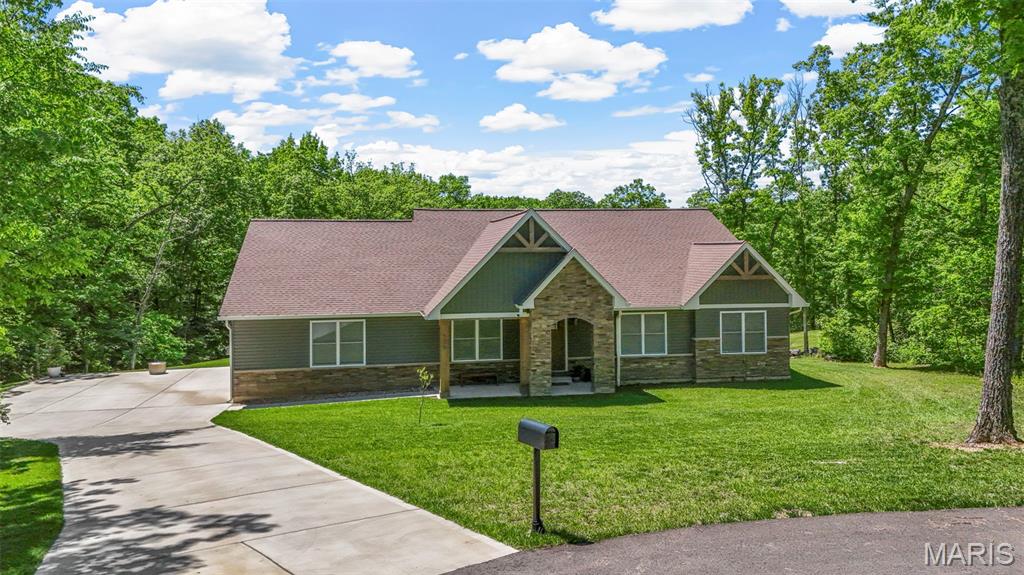 We will let the views speak for themselves, but you have to check out this beautiful lake front oasis! Tucked away at the back of a cul-de-sac in the sought after Summac Ridge Subdivision sits a newly built, custom home on 3 acres with 180 degrees of picturesque views of mature trees and gentle sloping hills. You're welcomed into a bright and airy open concept ranch  featuring tons of updates and tasteful colors. Spacious kitchen features solid wood cabinets, solid surface counter tops, stainless steel appliances with double oven, and HUGE center island overlooking the eating area and living room. Vaulted ceilings, floor-to-ceiling custom stone fireplace, high end lighting, and luxury vinyl plank flooring throughout create an elegant and cozy environment. Utilize the front flex room for a home office or formal dining area. The options are endless! Spend your summer nights entertaining under your HUGE covered patio overlooking your beautiful wooded lot. Expansive primary suite features tiled walk-in shower, separate soaking tub, dual vanity, and large walk-in closet. The main floor also features 3 additional spacious bedrooms with a semi split-bedroom floor plan including an additional full bathroom and additional 1/2 bathroom just off the kitchen. Thoughtfully created mud room and laundry room provides additional ample storage and cabinet space with custom built-ins and a pet washing station. Oversized side entry 3 car garage provides tons of extra space for all of your vehicles and extended driveway and cul-de-sac for additional parking for your guests. Lower level is unfinished and awaiting your creative touches. Pictures don't do justice. This is a MUST SEE and a perfect time to get in before the weather starts warming! FINALLY, the opportunity for you to own your DREAM HOME. Reach out to schedule your private showing today!