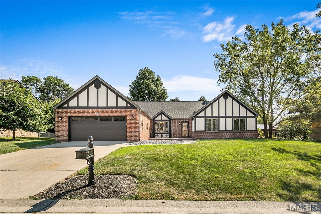 Welcome home to 204 Wild Cherry Lane, a beautifully updated brick ranch tucked into Rosewood Lake Estates in WOLF BRANCH Schools!  With 2,178 square feet all on one level, this beautiful ranch offers the ease of single-level living paired with the kind of thoughtful, top-to-bottom updating that is hard to find. Step inside and the first thing you will notice is the hardwood flooring, which runs through nearly the entire main level. The entry opens to a generous formal dining with room to comfortably seat ten, making holidays and entertaining easy to host. The kitchen is truly the heart of this home. Its 2021 remodel brought granite countertops, freshly painted cabinetry with new hardware, and stainless appliances including a slide-in double-oven range with built-in microwave above, a dishwasher, and disposal. A breakfast bar handles busy mornings and homework sessions, while a separate breakfast area offers a sunny spot for coffee, complete with its own serving bar and built-in storage. Just beyond the kitchen is a dedicated office, currently used as a work-from-home space but offers a lot of flexibility and can be used to fit your specific needs. At the far end of the home, the family room opens up beneath a vaulted ceiling. A fireplace anchors the space with a recessed niche built in above it for a television, and sliding doors lead out to a large new concrete patio, so warm evenings flow easily from inside to out. The peaceful, level backyard is the perfect spot to entertain friends and family. There is also plenty of room to add a pool! The primary suite is a true retreat. The bedroom features hardwood floors and two double closets, and French doors that open into a lovely bath that feels every bit as luxurious as it looks. A new, freestanding soaking tub takes center stage, joined by separate vanities (new tops, faucets, hardware and mirrors), a separate shower with a built-in seat, new vinyl flooring, lighting and new plank wall board.  Two additional bedrooms are both nicely sized with hardwood floors and double closets of their own. The hall bathroom serving them has been fully renovated with custom tile work and a doorless walk-in shower that feels elegant and high-end. A main-floor laundry room with extra closet storage sits conveniently between the family room and the garage, with a separate mechanical room alongside it. Six-panel doors and insulated casement windows carry throughout. Outside, the home is predominantly brick with stucco accents, set on a quarter-acre-plus lot with fresh exterior paint and new landscaping rock. The two-car attached garage enters at kitchen level and features a new garage door and opener.  Additional updates include repainted interior, new wiring in the kitchen, family room, and dining room, along with updated lighting and ceiling fans throughout. Best of all, there is no HOA. The location delivers, too. This address is served by Wolf Branch School District 113, with Belleville East High School beyond. The Swansea MetroLink station is minutes away with park-and-ride access to downtown St. Louis, the stadium district, and Lambert Airport. Scott Air Force Base is roughly fifteen minutes east, downtown St. Louis about twenty minutes west, and everyday shopping, dining, groceries, parks, and healthcare are all close at hand. Move-in ready, meticulously maintained, and beautifully updated throughout! Schedule your in-person showing today and be prepared to be WOWED from the moment you enter!