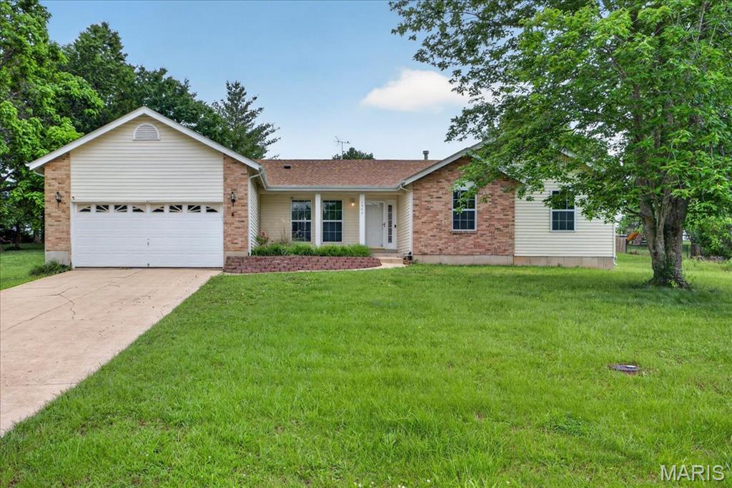 Coming Soon! Showings begin, Thursday, 5/28! Open House Friday (5/29), 4-6PM; Saturday (5/30) and Sunday (5/31), 1-3 PM! Rare .72-acre cul-de-sac opportunity in Pacific! This spacious ranch offers 1,730 sq ft on the main level, 3 bedrooms plus a study with a coffered ceiling, 2 full baths, a newer roof! Tucked away on a quiet cul-de-sac street, this home delivers the larger lot, peaceful setting, and  great open floor plan buyers are searching for.
Inside, you’ll find vaulted ceilings, great natural light, and a large great room anchored by a brick fireplace. The open flow between the kitchen, dining area, and main living space creates an easy everyday layout with plenty of room to gather and entertain. The kitchen features large peninsula with breakfast bar, stainless dishwasher, gas range & microwave, and convenient sightlines into the adjoining living area.
The primary suite is a standout with generous bedroom space and a private luxury bath featuring dual vanities, a separate soaking tub, and separate shower. Two additional bedrooms, a dedicated study with coffered ceiling, a second full bath, and main-floor laundry add flexibility and convenience. The full unfinished basement provides excellent storage and future finish potential, while the two-car garage and long & wide driveway allow you to park at least 6 cars!
Outside, the .72-acre lot offers a large usable yard with mature trees and room for outdoor living, gardening, play space, or future improvements. Located with convenient access to Pacific, Gray Summit, Eureka, I-44, parks, restaurants, schools, Shaw Nature Reserve, Route 66 attractions, and nearby outdoor recreation. This home needs cosmetic updates but offers the space, setting, and potential to create value in a quiet Pacific location!