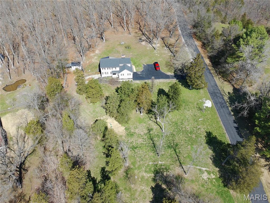 Continue Showing Welcome to your private retreat nestled on over 3 beautiful acres in the heart of Wildwood. This spacious 4-bedroom, 3-bath home offers the perfect blend of peaceful surroundings and modern updates—ideal for those seeking both comfort and space.
Step inside to find a light-filled open floor plan, featuring warm hardwood floors, inviting living spaces, and two cozy fireplaces that create the perfect atmosphere year-round. The primary suite offers a relaxing escape, while additional bedrooms provide flexibility for family, guests, or home office needs.
The home has seen extensive recent improvements, giving buyers confidence and peace of mind—including a new septic system, water treatment upgrades, new appliances. Roof replaced in 21 along with gutters and deck. 80 Gal water heater 3 years old and much more! Gourmet kitchen is outstanding beautifully open space walk in pantry. And plenty of custom cabinets.  
Enjoy outdoor living at its best with a huge, covered 16'x50' deck, perfect for entertaining or simply taking in the scenic, tree-lined setting. The property also features an outbuilding, ideal for storage, hobbies, or workspace. Additional highlights include: 2-car garage, Walkout lower-level waiting for your personal touch's and an extra Laundry room for another bedroom and bath, Blacktop driveway, Mature trees and private setting. This property offers the rare opportunity to enjoy quiet, acreage living in Rockwood Schools close to many shops and easy commute.
