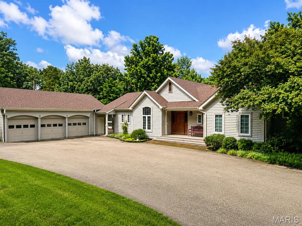 Open House Cancelled! Welcome home to this spacious and beautifully maintained 4-bedroom, 3.5-bath home designed for comfortable everyday living and effortless entertaining! Step inside to discover an inviting  floor plan with soaring vaulted ceilings, custom built-in cabinetry, and an abundance of natural light. The heart of the home is the expansive kitchen featuring a large center island, ample cabinetry, and direct access to the screened-in sun porch—the perfect place to enjoy your morning coffee, relax with a good book, or entertain family and friends while overlooking the backyard. The main level offers two spacious bedrooms with private access to a large appointed en suite featuring two oversized walk-in closets, a walk-in shower with overhead heat lamps, and a heated towel rack for a touch of everyday luxury. You'll also appreciate the oversized main-floor laundry room, convenient half bath, and abundant storage throughout. The finished walkout basement provides exceptional additional living space with two more generously sized bedrooms, a full bath, a huge family and recreation room, and a large maintenance room ideal for a workshop, hobbies, or extra storage. Whether you're hosting holiday gatherings, cheering on your favorite team, or enjoying a quiet evening at home, the two cozy fireplaces create the perfect ambiance on both levels. An oversized three-car garage offers plenty of room for vehicles, outdoor equipment, and all your toys. Combining generous living spaces, thoughtful updates, and timeless comfort, this home truly has room for everyone. Dual Heat/Air Conditioning Units. Schedule your private showing today and discover why this one feels like home the moment you walk through the door!