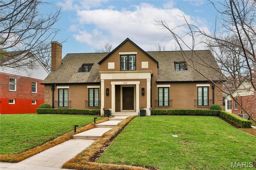 Artfully renovated down to the studs and expanded to the rear, this stunning Clayton Gardens home offers modern luxury just steps from downtown Clayton. The expansive great room boasts a 22’ vaulted ceiling, seamlessly integrating the living, dining, and family areas. The gourmet kitchen features a long island, hidden cabinetry, high-end appliances and a semi-circular breakfast area. The first-floor primary suite includes a spacious walk-in closet and bathroom w/heated floor. Add’l main-level highlights: powder room, library, office, and a convenient elevator to the lower level. Upstairs, find two bedrooms, a full bath, and a versatile storage room. The finished basement offers a rec room, collection room, half bath, and laundry area, plus Clayton's first in-terrain garage w/grass on top, mitigating heat and saving energy. Fenced yard, patio, sprinkler system, security cameras, & heated garage and driveway. Top quality design, workmanship & materials make this an outstanding offering.