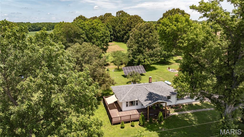 Escape to the peace and beauty of country living with this updated home situated on 20.61 scenic acres. Offering the perfect blend of modern comforts and rural charm, this property is ideal for those seeking space, privacy, and a connection to nature. The home features numerous updates and is surrounded by breathtaking views of the countryside. Step outside onto the expansive wraparound deck that spans two sides of the home, providing the perfect setting for morning coffee, outdoor entertaining, or simply enjoying the tranquil surroundings. The property is well-equipped for hobby farming and outdoor recreation, with approximately 11 acres currently leased to a local farmer, offering potential income. Animal lovers will appreciate the outbuilding complete with a chicken coop and run, as well as a fenced area designed for small livestock. A stocked pond provides excellent fishing opportunities and adds to the property's picturesque setting. Additional amenities include a carport, storage shed, and plenty of room to roam, garden, hunt, or enjoy the outdoors. Whether you're looking for a hobby farm, country retreat, or full-time rural residence, this exceptional property offers endless possibilities. Experience the beauty, versatility, and peaceful lifestyle this property has to offer! Updates include water heater, solar panels, kitchen, bath, windows, drywall, shed, and a new roof on the house.