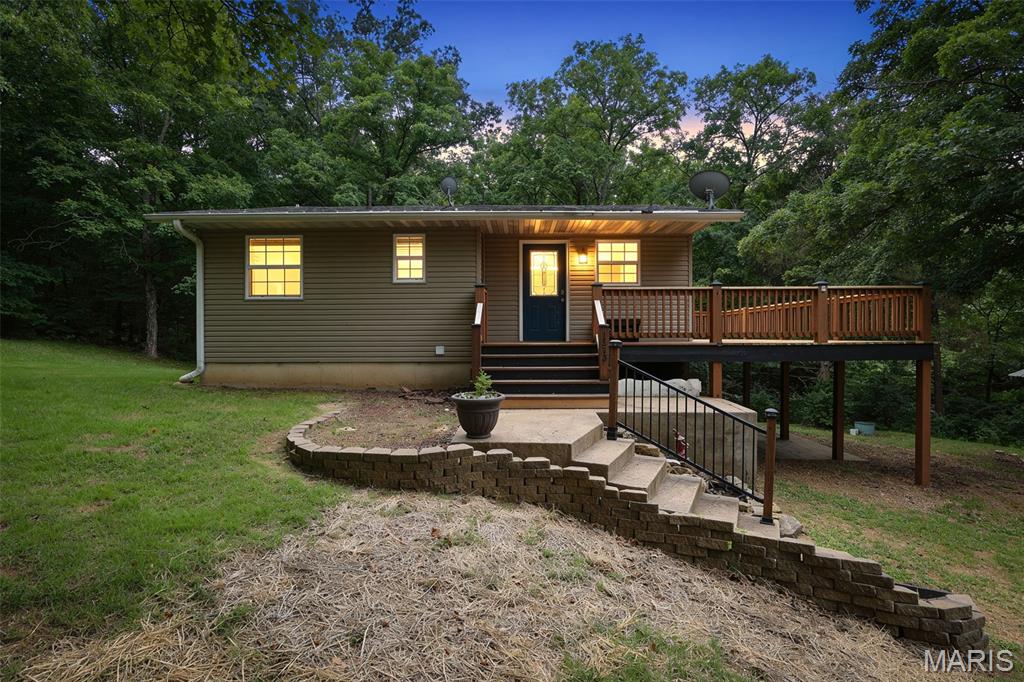 Nestled on a quiet cul-de-sac, this beautifully updated home offers a level of privacy that's hard to find in the Terre du Lac market. Situated on a double lot, the peaceful setting is surrounded by nature, creating a secluded retreat you'll love coming home to. Inside, you'll find tasteful updates throughout, blending comfort and charm. Just off the living room, a cozy sitting room with a beautiful fireplace provides the perfect place to relax while taking in the scenic views.
The private primary suite is tucked away on the lower level, offering a quiet retreat separate from the main living areas.Step outside onto the spacious deck and enjoy the peaceful natural surroundings. The patio is complete with a brick, wood-fired pizza oven, adding a unique touch that's perfect for entertaining or enjoying cozy evenings at home.
If you've been searching for a home with privacy, character, quality updates, and a setting that stands apart, this Terre du Lac gem is one you won't want to miss.
