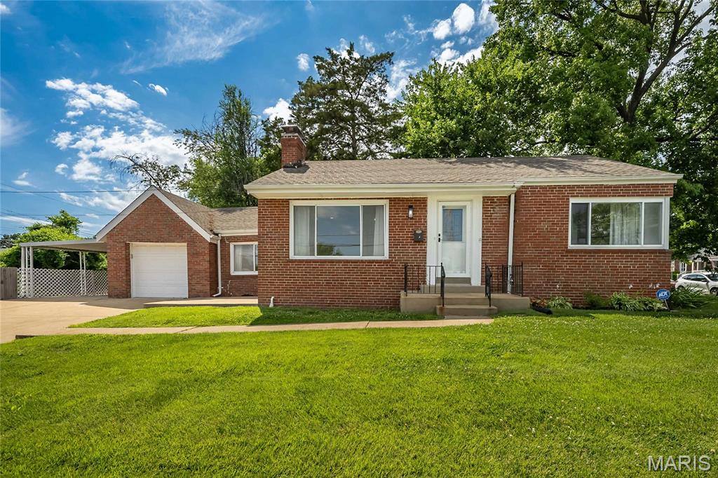 Welcome to this move-in-ready brick ranch that effortlessly combines classic charm with modern upgrades. Step inside to an inviting, open-concept living area featuring gorgeous, contemporary wood-look laminate flooring and a cozy fireplace with a distinct green tile surround . The seamlessly connected kitchen is a chef's delight, boasting updated crisp white cabinetry, sleek granite countertops, a modern tiled backsplash, and stainless steel appliances. The main floor also features three comfortable bedrooms and a beautifully styled full bathroom complete with a rustic barn-door vanity and custom tile tub surround. The space keeps going in the expansive, fully finished lower level! This massive bonus area features low-maintenance tile flooring and built-in wall shelving perfect for a media center. It includes a second full bathroom and a dedicated dry bar area with built-in shelving and pre-installed plumbing hookups—making it incredibly easy to convert into a full wet bar. Outside, the exterior features a convenient concrete patio tucked along the side of the home leading out to a massive, fully fenced side yard. The outdoor oasis is highlighted by a grand set of stairs that lead down to a beautifully hardscaped firepit area with mulch detailing, making it the ultimate spot for evening relaxation and entertaining. Don’t miss out on this total package—schedule your showing today!