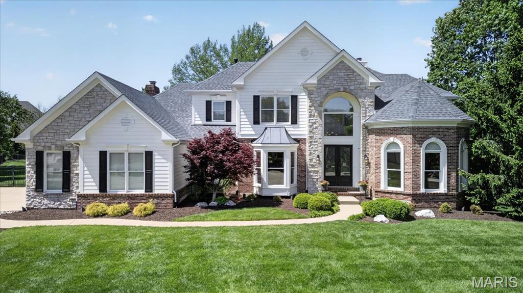 UNDER CONTRACT 4.25.26 - OPEN HOUSE CANCELLED
Step in to this exceptional 4BR/4.5BA 1.5 Story Home, perfectly situated on over half an acre level lot at the end of a quiet cul de sac. The professionally landscaped grounds, complete with accent lighting, set the tone for this stunning property, while the three car side entry garage and striking stone and brick elevation create unforgettable curb appeal.  A grand double door entry welcomes you inside to the impressive foyer, with soaring ceilings and dramatic T-staircase complimented by triple crown molding and beautifully arched cased openings leading to the Formal Dining Room and private Executive Office.   The Dining Room features wood flooring, a bay window, chandelier, chair rail and direct access to the Butler’s Pantry and Kitchen, perfect for seamless entertaining.  The Executive Office is a showpiece, highlighted by an architectural beamed ceiling, wainscoting, wood floors, recessed lighting, and three floor-to-ceiling arched windows that flood the space with natural light.  The Great Room is spacious and inviting, offering a wall of atrium windows overlooking the back yard, gas fireplace, ceiling fans, in ceiling speakers and exquisite triple crown molding.  The updated Kitchen has custom cabinetry, soft-close drawers, granite countertops, tile backspash and premium stainless steel appliances, including a Thermador five burner gas range with hood and a Bosch double wall oven.  A two-tiered center island offers ample seating, while the walk-in pantry and large sink with picture window enhance functionality.  The Kitchen flows into the Breakfast Room and Vaulted Hearth Room, featuring a brick gas fireplace and wall of transom-topped windows overlooking the back yard oasis.  The main floor Primary Suite is a serene retreat, with crown molding, ceiling fan and two walk in closets. An En Suite Primary Bath has been fully remodeled and delivers a spa like experience, with heated tile floors, oversized walk in shower with seating and multiple Grohe showerheads, a free standing soaking tub, custom cabinetry, quartz topped comfort height vanities, and a TOTO bidet commode for ultimate comfort.  Upstairs are three generously sized bedrooms-one with a private en suite bath, and two connected by a Jack and Jill bath- all with walk in closets.  The Finished Lower Level adds more living space with LVP flooring, large Family/Recreation Room, walk behind bar, exercise room, full bath and abundant storage space.  Outside, the resort style back yard is an entertainers dream. Exit to a covered patio with a vaulted wood ceiling, recessed lighting and fan, to a stunning Gunite Pool with waterfall and expansive fenced green space. Exterior speakers complete the perfect setting for gatherings and relaxation. Additional highlights include a level and usable back yard, new roof (April 2026), zoned heating and cooling, 75 gallon water heater, and full irrigation system, ensuring comfort, efficiency and peace of mind.  This home blends timeless elegance with modern upgrades and exceptional indoor/outdoor living - truly a rare opportunity!