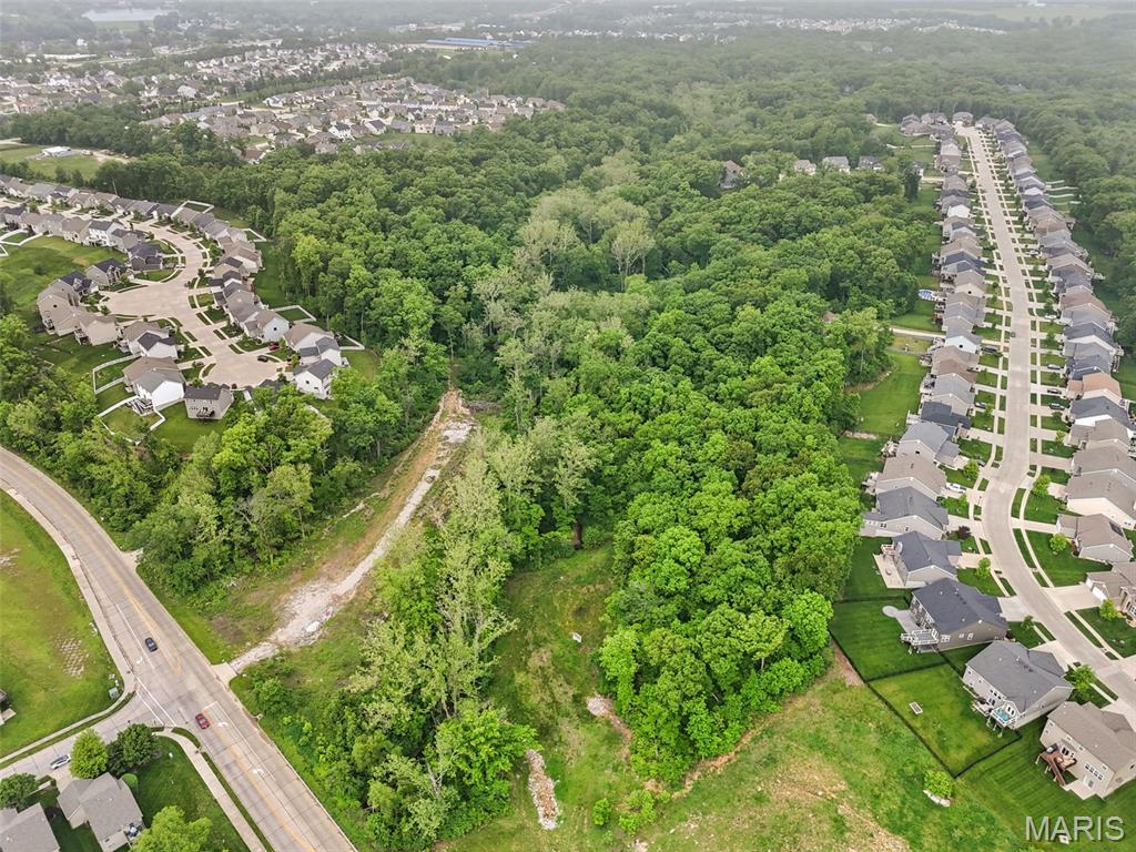 Outstanding location with 30 + acres, all city utilities and NO FLOODPLAIN and NO WETLANDS!  Just a quarter mile north of the main Lake St Louis overpass on Guthrie Road! remember the three most important things with regard to RE... location, location and location! This is the perfect place for a new residential subdivision if you want to be sold out fast!  Easy access to I-70 and I-64 but no road noise to speak of!  Rolling hills and some very level ground make this a beautiful place for residential development with large lots or Villas with "Green Space"! There is a small spring fed creek that makes this property perfect for walking trails and common ground! This tract would make a fantastic place for a family compound or your private estate!   Property in this area, and this close to everything, with sewer and water accessible, is a "no brainer".  If you can find a better piece... buy it!  Nice newer homes in the immediate area! Schedule your private tour today!