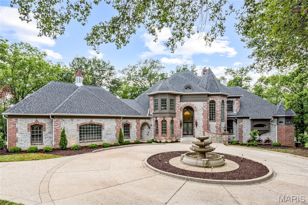 Crafted by renowned builder J.L. Wise and designed by William D. Cover, this extraordinary estate offers timeless architecture, masterful design, and serene golf course views—all nestled on 1.27 private, manicured acres on a prestigious private lane in Whitmoor Country Club. A striking brick and stone exterior with intricate rooflines creates unforgettable curb appeal, further elevated by a circle drive and a sculptural fountain by artist Bob Cassilly. Leaded glass doors open to 2-Sty marble foyer enhanced by Schonbek crystal chandeliers & dramatic floating staircase leads to elegant dining room & stunning great room with marble fireplace, wet bar & dramatic 2-sty bay window that offers perfect views of the 9th hole on the South course. Recently updated designer kitchen with 42” white cabinetry, exotic granite countertops, commercial grade appliances, 9’ center island & butler’s pantry adjoins light-filled breakfast room & vaulted hearth room with beamed ceiling & fireplace. Coffered primary bedroom suite features a see-through fireplace, beautifully appointed marble bath with shower spa & sitting room. The 2nd floor extends the living quarters with 2 additional ensuite bedrooms. Lower Level includes recreation room with stone fireplace & wet bar, media room, study with bespoke paneling, fitness studio & guest suite. Situated on a private lot with expansive driveway, 2 decks with newer decking, screen porch, patio, gazebo & oversized 4-car garage with storage loft.