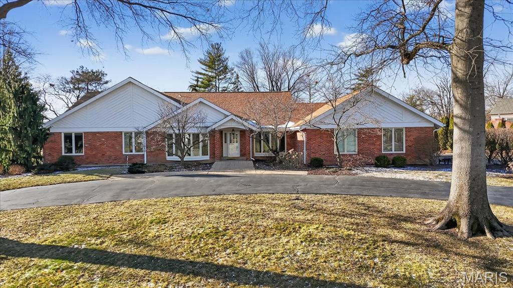 This is the one - A spectacular 4BR/2.5BA ranch in Town and Country’s highly sought-after Barrington Place subdivision, beautifully set back on a level 1-acre corner lot with circle drive, mature trees, lush landscaping, and an inviting in-ground pool. The open-concept floor plan welcomes you with a foyer flanked by formal living and dining rooms and leads to a dramatic vaulted great room featuring a floor-to-ceiling brick fireplace, built-in wet bar, large windows, and French doors opening to the backyard.
The well-appointed kitchen offers rich wood cabinetry, granite countertops, large center island with seating, double ovens, warming drawer, and expansive pantry wall. A bright breakfast room with French doors leads to the patio, while a convenient laundry/mudroom connects to the oversized side-entry 3-car garage. The spacious primary suite includes a walk-in closet and updated en-suite bath with dual vanities, soaking tub, vaulted ceiling, and separate shower. Three additional generously sized bedrooms share an updated hall bath.
The lower level provides excellent expansion potential with high ceilings and a full bath rough-in. Outdoor living shines with a large stamped concrete patio leading to the beautifully maintained in-ground pool framed by stone walls and thoughtful plantings - ideal for entertaining or relaxing. Conveniently located near highways, hospitals, shopping, and award-winning Parkway schools. Lovingly maintained for years by the original owners, this special home now awaits its new owners.