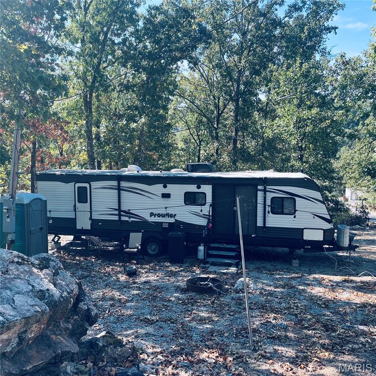 Ready for lake life? This turnkey recreational lot is waiting for you! Located in a gated lake community with a 400+ acre lake, pool, beach, and more. The lot is cleared, comes with a 50 amp hookup AND a beautiful 2017 37-ft camper with slide outs. Bring your boat, your floaties, and your friends – fun is included year-round with organized events, 24/7 security, and amenities galore!