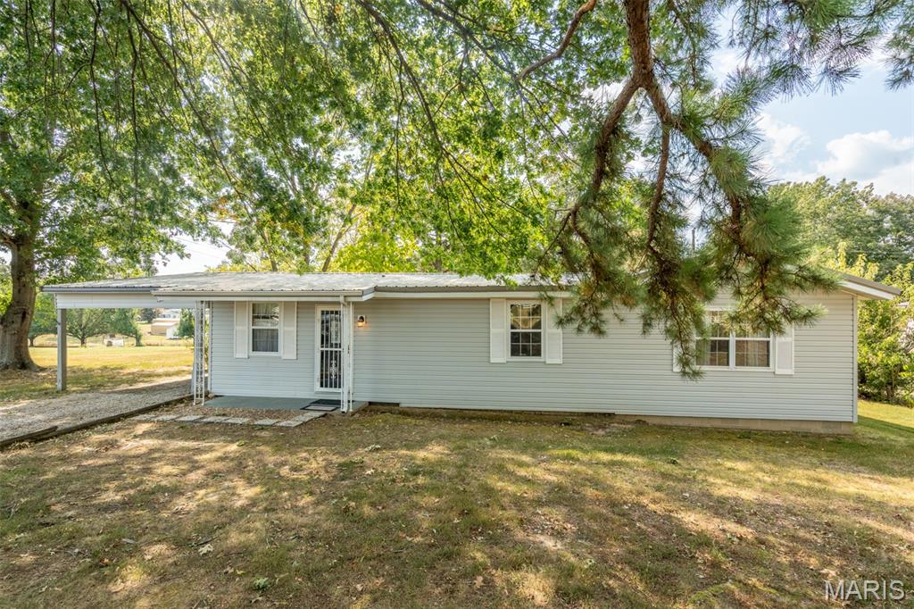 Discover this inviting 3 bedroom, 2 full bathroom home offering 1632 sq ft living space with plenty of room to make yours! This home has recently had some updates and remodel, making this move-in ready! Fresh paint throughout, new rear entry, and updated porch. The spacious living area features higher ceilings and flows seamlessly into a full dining room perfect for entertaining! All bedrooms are generously sized, and the main bathroom is extra-large! The home includes an attached carport for easy parking. Sitting on a double lot, the property boasts a huge backyard, offering endless potential for outdoor fun, gardening, or gatherings. Recent updates include a new septic tank for peace of mind and a survey is available.  Location is key- this property is just one mile to Rockwood Point boat dock and Wappapello Lake, making this ideal for lake lovers! Whether you are looking to live at the lake full time or wanting to expand your investment property, this house is for you!