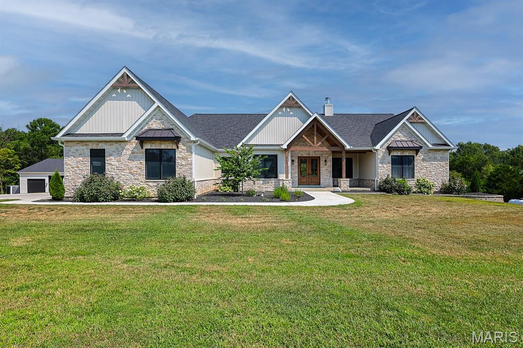 WELCOME HOME! This must-see home is located in sought after Foristell, St. Charles County (Wentzville Schools). Step into luxury with the custom-built home featuring 4 bedrooms, 3 1/2 baths all on the main level, a custom office with built-in dual desks, perfect for remote working. The kitchen is a chef's dream complete with a 48" gas range, large fridge/freezer, custom cabinetry with all the features, a walk-through matching cabinet pantry, and all quartz countertops. Fully finished basement ready to move in and entertain. Separate bedroom and bathroom, designated playroom for kids, living room/rec room/kitchenette, and a fully equipped theater room. The house has it all, but don't forget exterior features. The detached 60ft x 60ft garage space with a 14ft garage suitable for RV parking as well as a half bath. Outside you find a wood burning fireplace on the deck ready for cool fall nights. The patio has built in gas grill, and the yard is ready to put in your dream pool with exterior access to the basement bathroom. You can have all of this and must more on 5.76 acres. Schedule your showing today and don't miss your opportunity to snag this one of a kind! Agent Owned.