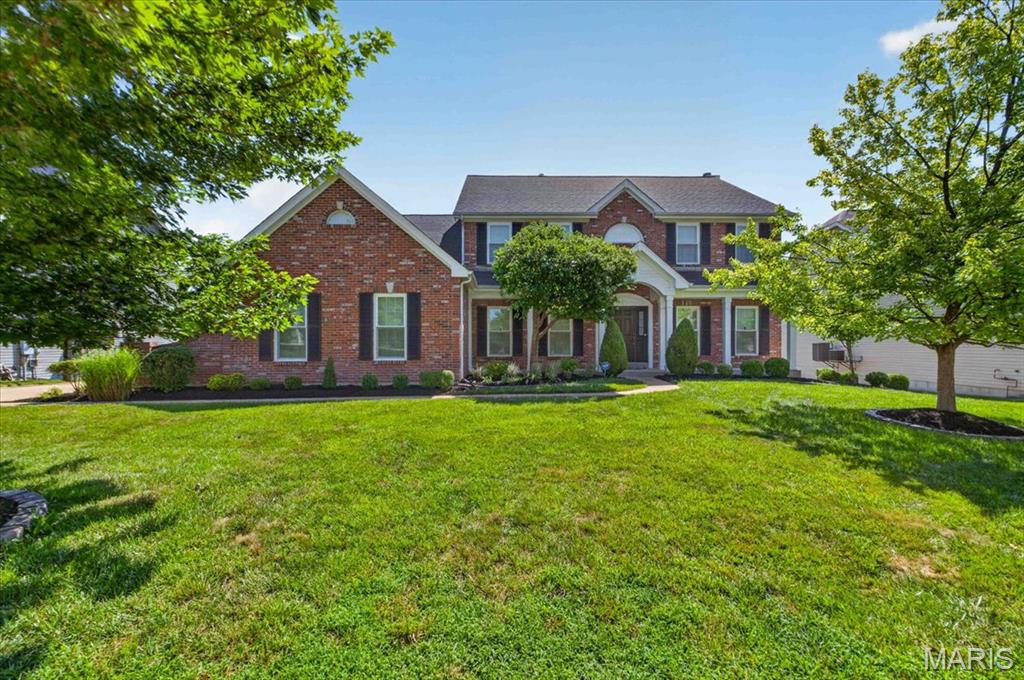 Discover exceptional craftsmanship and refined living in this former display home, perfectly positioned within the highly sought after Lindbergh School District and the prestigious Tapawingo National Golf Course subdivision. This 4 bedroom, 4.5 bath residence offers a stately brick elevation, a 3-car side entry garage, and a thoughtfully designed floor plan that blends everyday comfort with impressive entertaining spaces.
Recent improvements include new architectural shingle roof (2022), new windows in the great room/living room (2024), new front facing windows (2025), Trex composite deck (2025), new exterior paint plus new sunroom and kitchen windows (2026)—providing peace of mind and enhanced curb appeal.
Inside, a ceramic tiled foyer introduces an elegant office and formal dining room. The two-story great room commands attention with its dramatic wall of windows and cozy gas fireplace. The hearth room offers a second gas fireplace and serves as an intimate gathering space overlooking the private wooded backdrop and expansive deck.
The gourmet kitchen is designed for both culinary excellence and effortless hosting, featuring abundant cabinetry, granite countertops, and a center island cooktop. A powder room and main floor laundry complete this level with convenience and style.
The primary suite is a true retreat, offering vaulted ceilings, his and her closets, and a spa inspired bath with double vanities, jetted tub, and separate shower. There is additional storage space located off the primary suite creating the perfect space to convert to an expansive luxury walk-in closet.  Each spacious additional bedroom enjoys direct access to a bathroom—one with a Jack and Jill layout and the other with a private ensuite—providing comfort and privacy for family or guests.
The finished walkout lower level extends the luxury living experience with full size windows that create a seamless connection to the main level. This exceptional space includes custom flooring, a full bath, a private sauna, and direct access to the patio—ideal for relaxation or entertaining.
A rare combination of architectural elegance and premium updates, this residence delivers a lifestyle defined by comfort, sophistication, and long-term value. Whether hosting memorable gatherings or enjoying serene evenings at home, this property offers an unparalleled blend of luxury and livability.