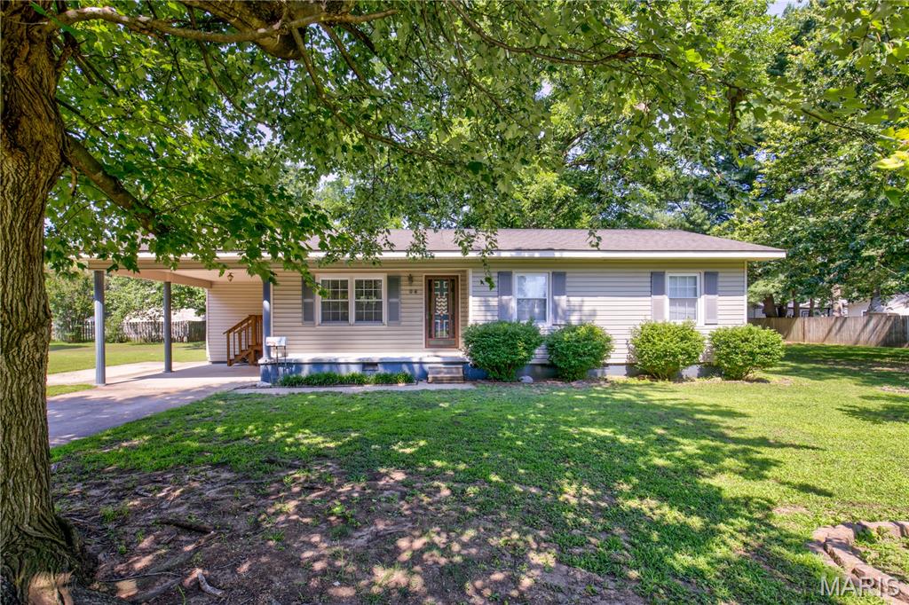 Are you looking for a huge yard in town!?  This 2 bedroom 1.5 bath home sit on .79 of an acre in town!  The home was once a 3 bedroom and was converted to 2 bedroom.  Entry from the carport leads right into the laundry room for convenience.  The kitchen and dining are together and you will immediately notice the large and beautiful sky light!!  If you love natural light you will love how this lights up the entire kitchen!  A large living area is right off the kitchen.  Down the hall you will have the primary bath to the right which has a half bath in it.  The is also a main bath in the hall that is very large!  The second bedroom on the house is a good size with a large closet!  This home also come with multiple lots that equal .79 of an acre with mature trees and an outbuilding!  Schedule your tour today!!