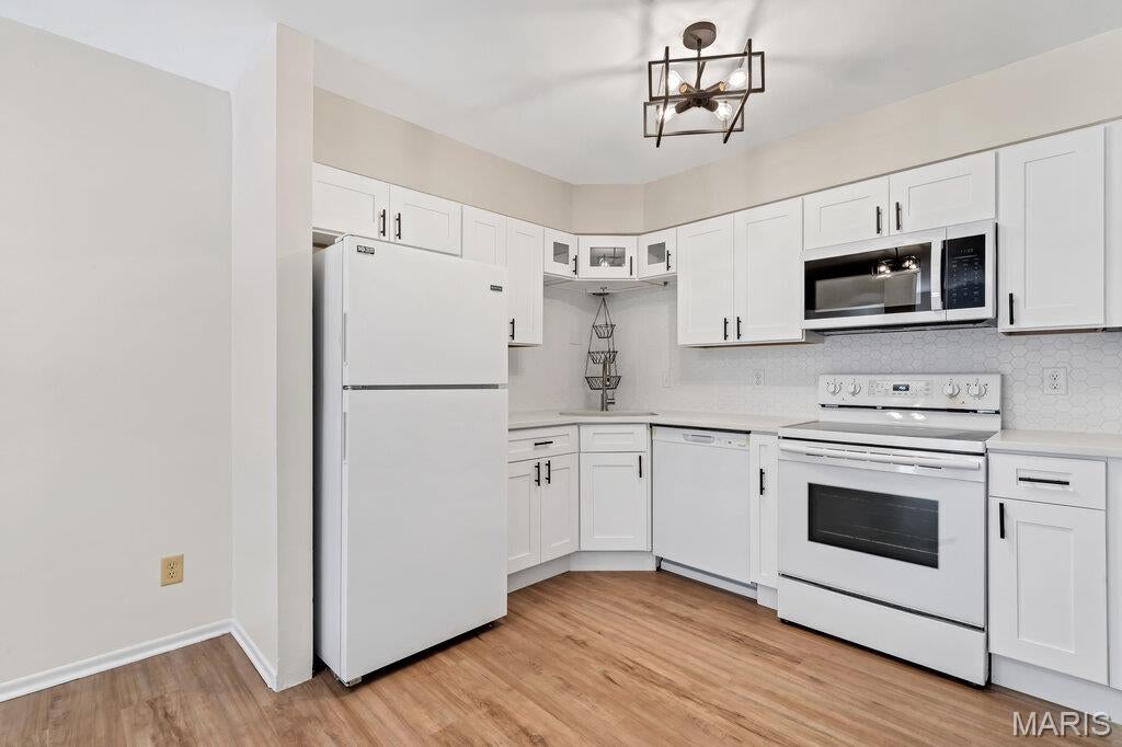 Welcome to turn-key living in sought-after Oakville Commons! This beautifully updated condo has been refreshed from top to bottom giving it a modern design and functionality. Step inside to discover a bright, open floor plan featuring brand-new luxury vinyl plank flooring, fresh paint from top to bottom, and contemporary lighting throughout. The chef-ready kitchen shines with brand-new white shaker cabinets, premium quartz countertops, modern tile backsplash, and an undermount sink with new brushed nickel faucet. Off the main living and dining area, sliding glass doors lead to your private rear deck—an ideal retreat overlooking mature shade trees. Retreat upstairs to find brand-new plush carpeting and generously sized bedrooms, each boasting ample closet space. The front room features a space for an office for those who work from home! Additional conveniences include private in-suite laundry, a private garage, a ton of storage space in the basement, plus assigned parking space. Other updates include newer EnergyView windows upstairs, newer walk-in shower, newer electric panel and upgraded wiring. Community perks include full access to the Oakville Commons clubhouse, outdoor swimming pool within a 2 minute walk, and sun deck with picnic tables and BBQ pit. Virtually maintenance free living! Convenient to shopping, dining, parks, and major highways—just move right in and enjoy! Owner-Agent.