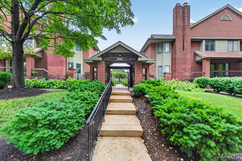Welcome home to this charming condo nestled in a beautifully maintained all-brick community featuring elegant wrought iron accents, lush landscaping, and a secure wrought iron gated entrance. From the moment you enter, you'll feel like you're stepping into a private resort with its inviting courtyard setting and sparkling inground pool. Inside, you'll appreciate the open floor plan accented by rich wood flooring, 4 1/4-inch baseboards, a cozy wood-burning fireplace flanked by custom built-in bookshelves, and a beautiful bay window that fills the space with natural light. The sliding glass door opens to your private patio overlooking the community pool—the perfect spot to relax or socialize with neighbors. The updated kitchen offers granite countertops, stainless steel appliances, a tile backsplash, and a pantry for added storage. The washer and dryer are included, making your move even easier. Additional conveniences include a climate-controlled community garage with private storage and garage doors at both ends for easy access. Enjoy an unbeatable location with hospitals, restaurants, coffee shops, and everyday conveniences all within walking distance. It's easy to see why the current owner has loved calling this community home!