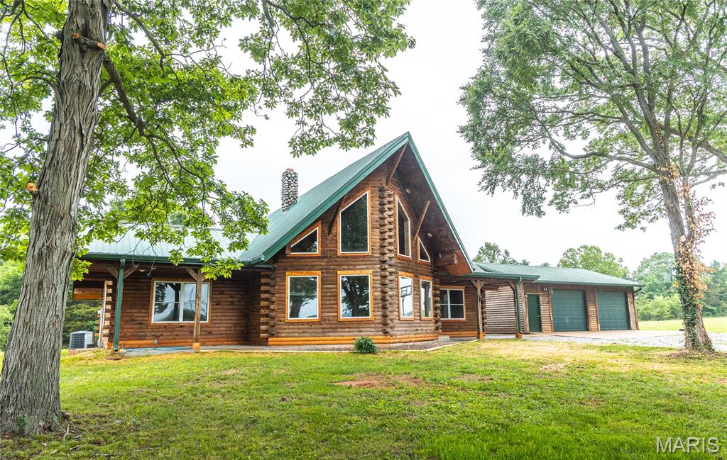 Tucked away on 9.84 beautiful, highly desirable acres, is this stunning 3 bedroom/2 bath log home which offers the perfect blend of rustic charm and modern updates. Inside you’ll find a gorgeous rock wood-burning fireplace that creates a warm inviting centerpiece for the home. The open floor plan offers plenty of natural light.  Recent improvements include new flooring, new countertops, updated bathrooms, new gutters, updated plumbing and more for added peace of mind. This home is filled with warm wood finishes including knotty pine walls, and beautiful knotty pine cabinets that perfectly complement the log home design.  Enjoy the outdoors from two covered porches on the front or relax on the concrete back patio overlooking the peaceful property. A two-car garage is also located next to the house. Access is from an asphalt county road to a private gravel drive.  Beautiful shade trees include oak, maple, shag bark hickory and more.  Nearby you can enjoy endless recreational opportunities on National Forest land including hiking trails, hunting, bird watching, and fishing at the beautiful Council Bluff Lake.  Elephant Rocks State Park is within 15 minutes offering one of Missouri’s most unique national attractions. Take time to relax and enjoy an ice cream or coffee in the charming village of Caledonia. This place is one of a kind, has character and charm.