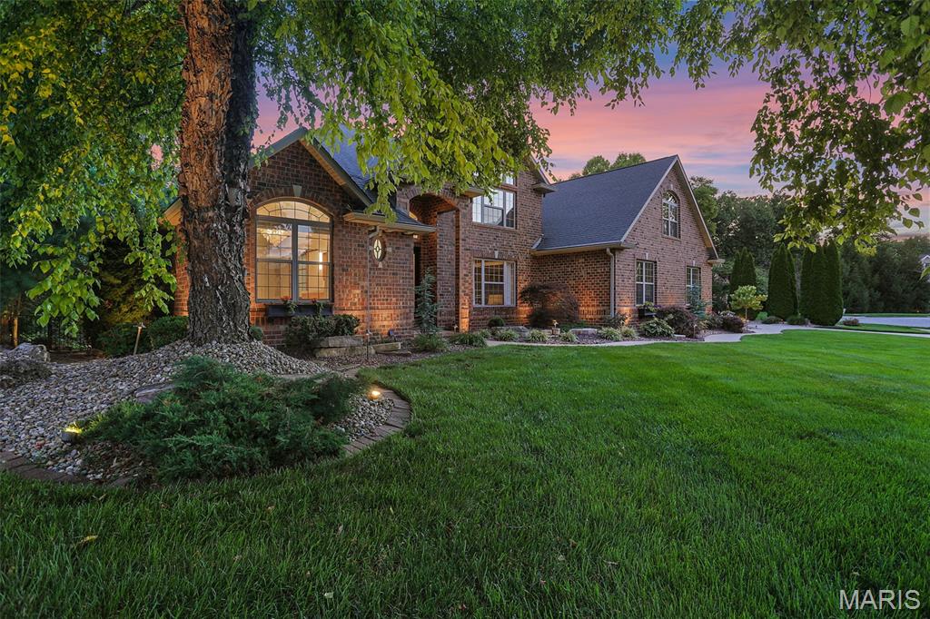 Experience luxury resort-style living in this extraordinary custom-built estate nestled on 2.63 secluded acres within The Landings at Far Oaks. Built in 2007 and offered by its original owner, this remarkable 1.5-story home features over 6,000 square feet of finished living space, 4 bedrooms, 5 full baths, 1 half bath, laundry on all three levels, and a full walkout lower level designed for entertaining and relaxation.
Surrounded by mature trees and professional landscaping, the private backyard retreat showcases a heated saltwater pool with waterfall and lounging deck, outdoor bar beneath a pergola with built-in grill, fire pit, covered TV lounge, private exterior bathroom with shower, and multiple gathering spaces creating the ultimate outdoor oasis.
Inside, timeless craftsmanship and luxury finishes abound. The gourmet kitchen is appointed with premium Thermador appliances including refrigerator and freezer columns, built-in luxury coffee system, 8-burner gas range, wine chiller, and dishwasher, KitchenAid trash compactor, dual pantry closets, custom cabinetry, reverse-osmosis water tap, marbled quartz countertops, expansive center island, and travertine flooring. 
The main-floor owner’s suite is a private sanctuary featuring a fireplace, attached study overlooking the backyard, spa-inspired bath with Japanese soaking tub, oversized double walk-in shower, private water closet, separate dual vanities, and a designer walk-in closet measuring approximately 20’ x 6’. Additional main-level spaces include a formal dining room, dramatic two-story living room with floor-to-ceiling windows and fireplace, hearth room with fireplace, screened outdoor hearth room with fireplace, laundry room, and powder bath.
The upper level offers three spacious bedrooms with walk-in closets, a large library with climate-controlled stove fireplace, two full baths, and a second laundry room.
The walkout lower level includes a family room with fireplace, full kitchen, dining area, lounge, game room, reading nook, fitness center with dual-system sauna, full bath, laundry area, and direct access to the outdoor entertaining spaces and pool area.
The property’s wooded acreage includes over 1,200 feet of dry creek bed ideal for hiking and exploring, with abundant morel mushrooms in season. Residents enjoy direct golf cart access to Far Oaks Golf Club. Additional features include a 3-car garage with dedicated storage area. 
Entire home has been remodeled and upgraded since the original build.
A rare opportunity to own one of the Metro East area’s premier luxury estates.