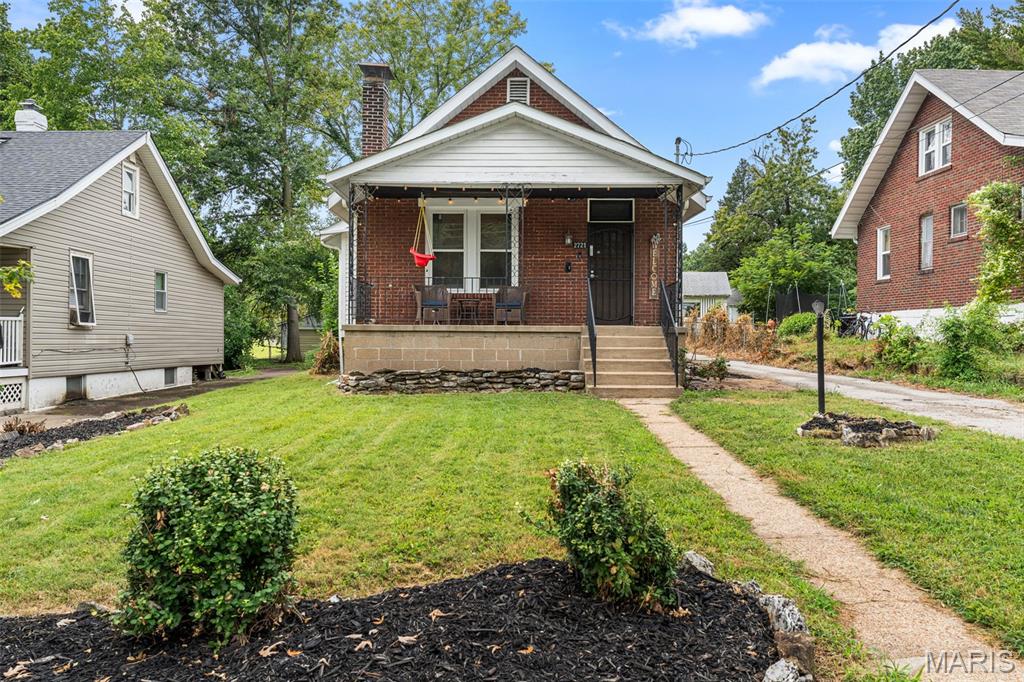Welcome to 2721 W Tennyson Avenue, a charming 1920s home filled with character and so much potential! Step inside to find original hardwood floors, updated windows and the kind of details that give an older home its warmth and personality. The living room features a fireplace that creates a cozy focal point.This 2 bedroom home offers comfortable living spaces with plenty of natural light, while the clean basement provides even more flexibility. A portion is currently sectioned off as a casual hangout space and office, making it easy to create a home workspace, hobby area, workout space, game room or additional storage. Outside, the large, covered front porch spans the front of the house. It's the perfect place to sit and enjoy your coffee or relax at the end of the day. The large, level, fenced backyard is ready for whatever you envision. There is plenty of room for pets, gardening, entertaining, a firepit, play area or future outdoor living space. Whether you dream of summer barbecues, raised garden beds or simply having a big backyard to enjoy, there are so many possibilities. Located in the heart of Overland, this home offers the convenience of being close to shopping, restaurants, parks, everyday necessities and major interstates like I-170, making it easy to get to Clayton, University City, the airport and really anywhere in the St. Louis area. Overland also offers numerous city parks and recreation options. If you have been looking for an affordable home with original charm, a great backyard and a central St. Louis County location, 2721 W Tennyson Avenue is one you will want to see!