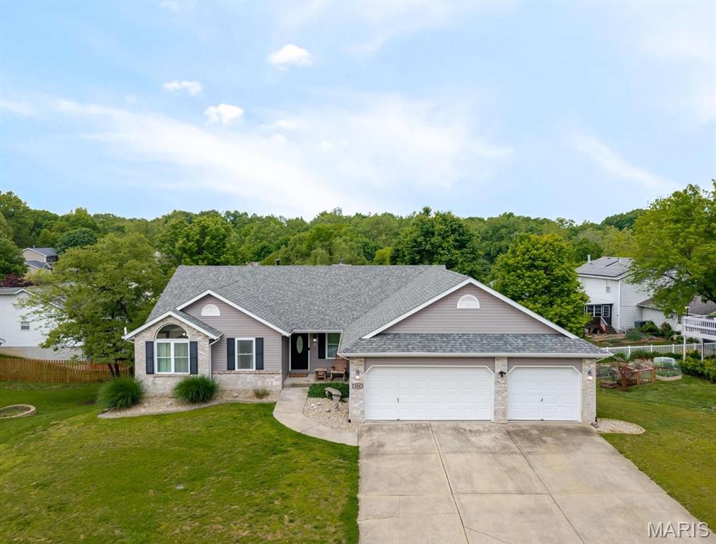 Welcome to 204 Aspen Point! This beautiful 4-bedroom ranch offers real wood flooring, a finished walkout lower level, and a spacious backyard in a quiet subdivision near Miner Park and the bike trails. The kitchen is designed for both everyday living and entertaining, featuring a large center island, granite countertops, tile flooring, stainless steel appliances, and easy access to the deck. Just off the kitchen, you’ll find a spacious main floor laundry room conveniently located near the oversized 3-car garage, complete with a 40-amp electric hookup. The primary suite features cathedral ceilings, an oversized walk-in closet, and a luxurious ensuite bath with a tiled walk-in shower, whirlpool tub, double vanity, and granite countertops. The finished walkout lower level offers an entire second living space with a large family room, full bath, private fourth bedroom with walk-in closet, and an additional non-conforming room with its own oversized walk-in closet — ideal for a home office, gym, hobby room, or guest space. Major updates include a new roof plus HVAC, AC, and water heater all replaced in April 2025 (approximately $17,000 in improvements not including cost of roof). This well-maintained home offers space, flexibility, and an excellent location close to parks, trails, shopping, and interstates.