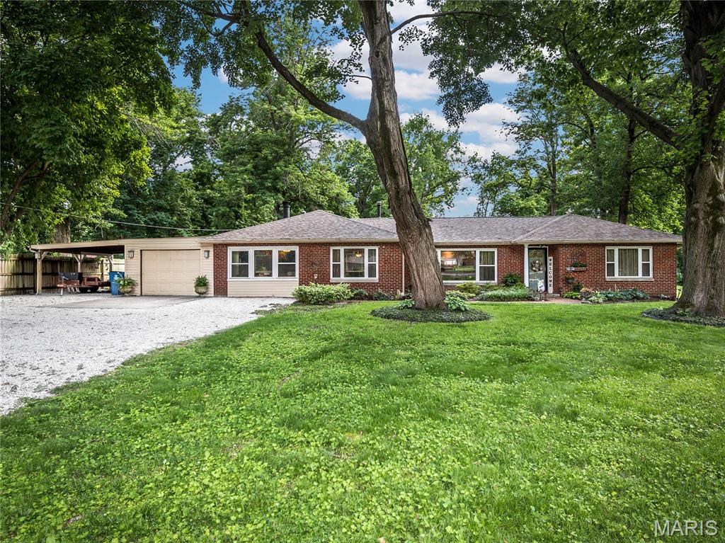 Nestled on a beautifully landscaped 1.75 ACRE LOT, this sprawling brick ranch offers over 1800 sq ft and the perfect blend of space, comfort and updates throughout! 2 Bedroom with Dedicated Office space w/Ensuite bath. Large living room with beautiful hardwood floors that flow into the dining room with charming, lighted built-ins. The recently remodeled kitchen is sure to impress with new soft close cabinetry, stunning granite countertops, center island with lighted pot rack, new appliances featuring a 5 burner gas range and seller added a great sized pantry for extra storage. The breakfast room is larger than most and filled with natural light from a oversized window, while the FAMILY ROOM offers a cozy wood burning fireplace (with newer liner and chimney in 2021) and surround sound speakers that will remain. Two bedrooms are nicely sized and separated by an updated hall bath. OFFICE has a 1/2 bath ensuite. You will love the sunroom overlooking the expansive, private back yard with access to the patio - perfect for entertaining! One Car attached garage and two car carport with large driveway for lots of extra parking! Large shed in back with asphalt floor and has electric - for extra storage! All new windows in 2019.