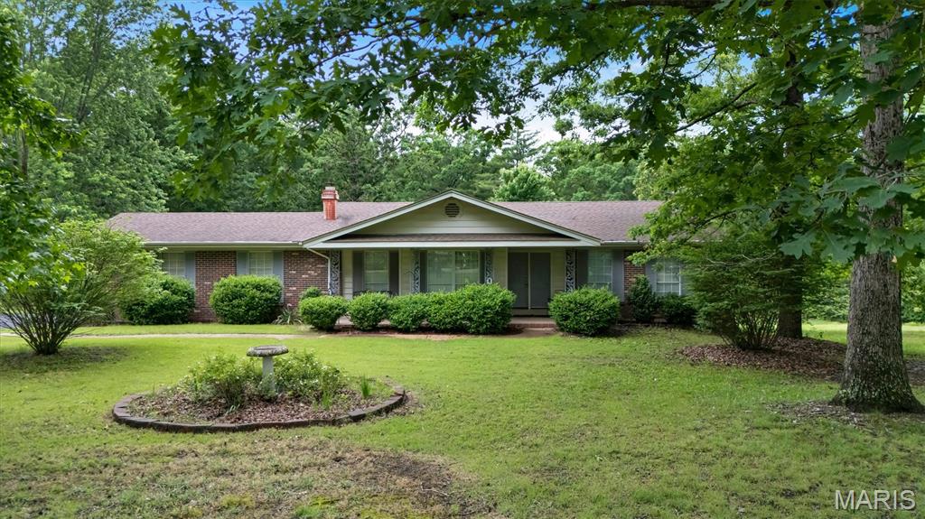 Must-see home situated on 2.5 private acres with beautiful mature tree growth, offering the perfect blend of updates, space, and potential! This 3-bedroom, 2-bath home features over 1,400 sq ft above grade plus a partially finished walkout lower level with endless possibilities. The oversized 2-car garage provides plenty of room for vehicles, storage, and hobbies.

The meticulously updated kitchen has been newly remodeled with custom oak cabinetry, sleek new countertops, stainless steel appliances, a functional custom island, and spacious attached dining area perfect for everyday living and entertaining. The inviting living room showcases a stunning custom tile fireplace accented by custom built-ins, creating a warm and stylish focal point.

The spacious primary suite features a beautifully updated en suite bath with custom tile shower. Additional recent improvements include newer roof, HVAC, hot water heater, and water softener, providing added value and peace of mind. The walkout lower level offers additional living space with opportunity to expand, customize, or create the perfect recreation area, home office, or guest space.

Enjoy peaceful living with the convenience of modern updates, scenic surroundings, and room to grow. This property is truly one you won’t want to miss!