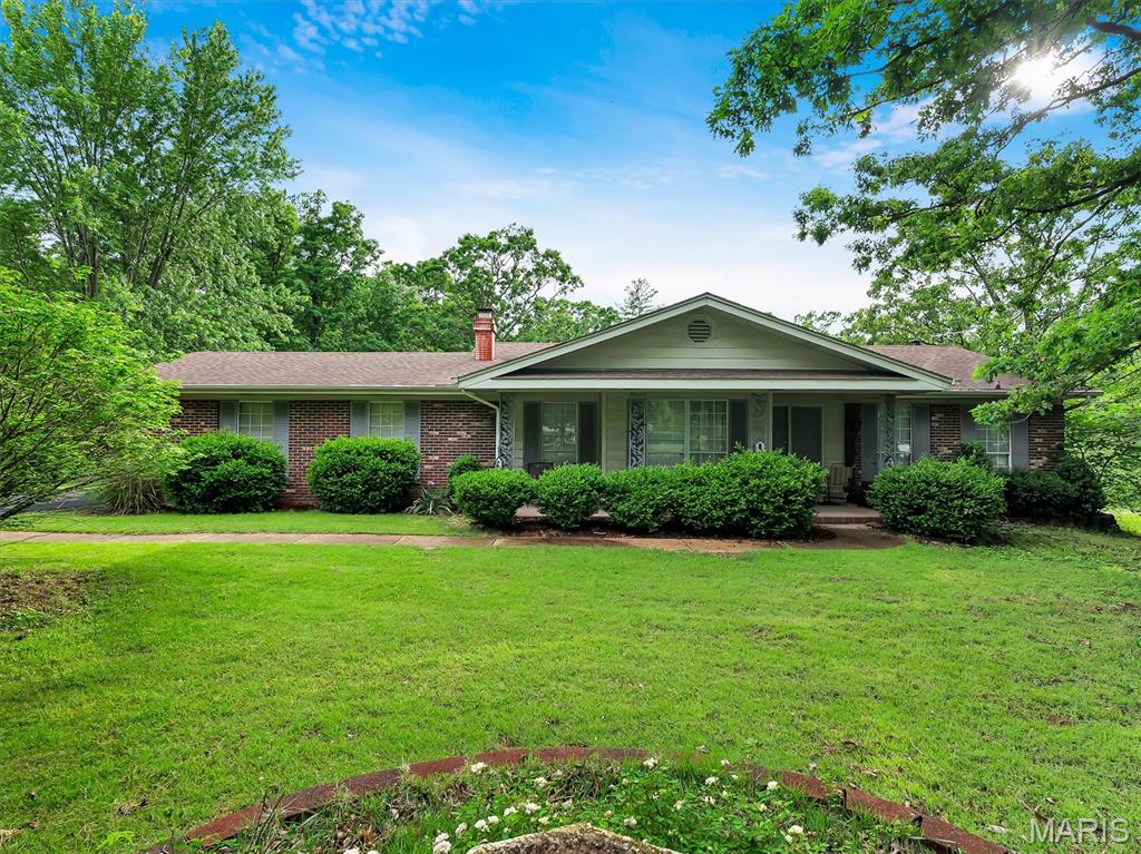 MOTIVATED SELLER! Must-see home situated on 2.5 private acres with beautiful mature tree growth, offering the perfect blend of updates, space, and potential! This 3-bedroom, 2-bath home features over 1,400 sq ft above grade plus a partially finished walkout lower level with endless possibilities. The oversized 2-car garage provides plenty of room for vehicles, storage, and hobbies.

The meticulously updated kitchen has been newly remodeled with custom oak cabinetry, sleek new countertops, stainless steel appliances, a functional custom island, and spacious attached dining area perfect for everyday living and entertaining. The inviting living room showcases a stunning custom tile fireplace accented by custom built-ins, creating a warm and stylish focal point.

The spacious primary suite features a beautifully updated en suite bath with custom tile shower. Additional recent improvements include newer roof, HVAC, hot water heater, and water softener, providing added value and peace of mind. The walkout lower level offers additional living space with opportunity to expand, customize, or create the perfect recreation area, home office, or guest space.

Enjoy peaceful living with the convenience of modern updates, scenic surroundings, and room to grow. This property is truly one you won’t want to miss!